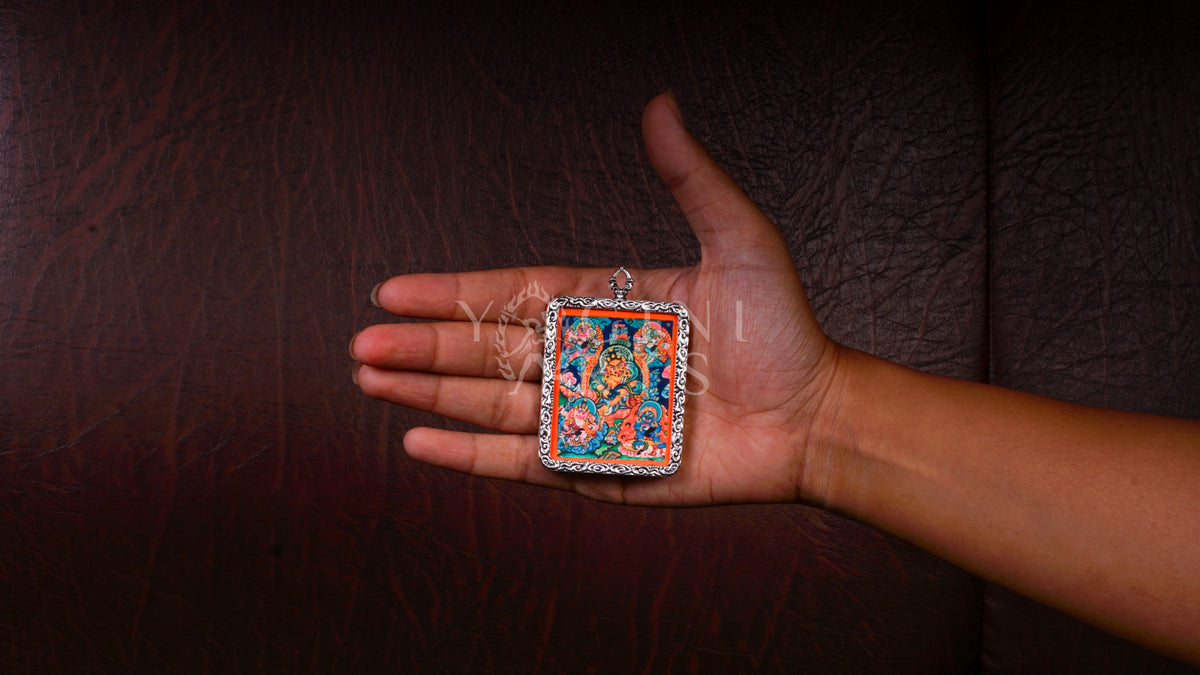 Hand-painted Five Zambhala Ghau pendant featuring the Five Buddhist Wealth Deities in a handcrafted silver-tone frame made in Nepal.