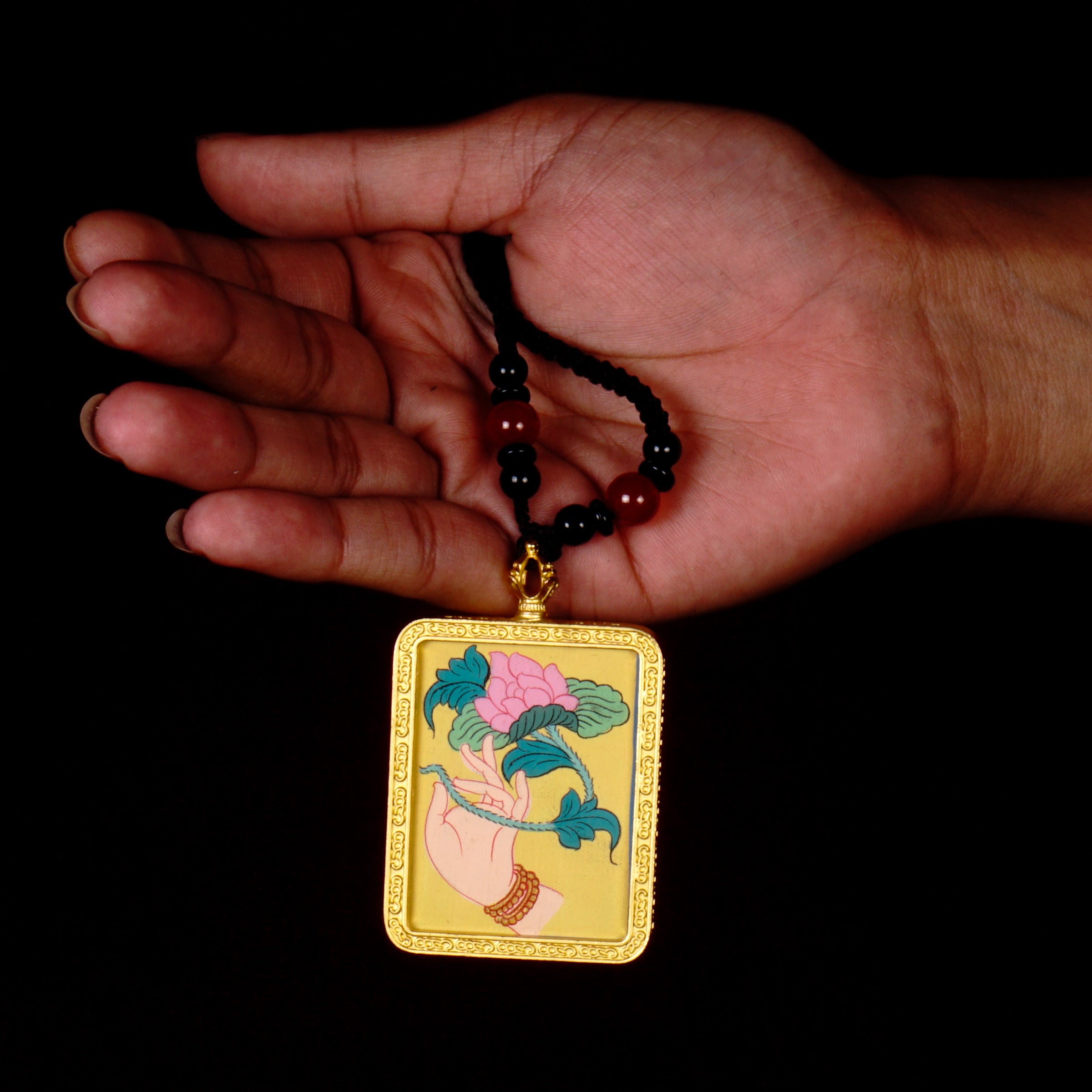 Hand-painted lotus flower in sacred hand miniature Thangka pendant inside gold-accented copper Ghau locket with black beaded cord.