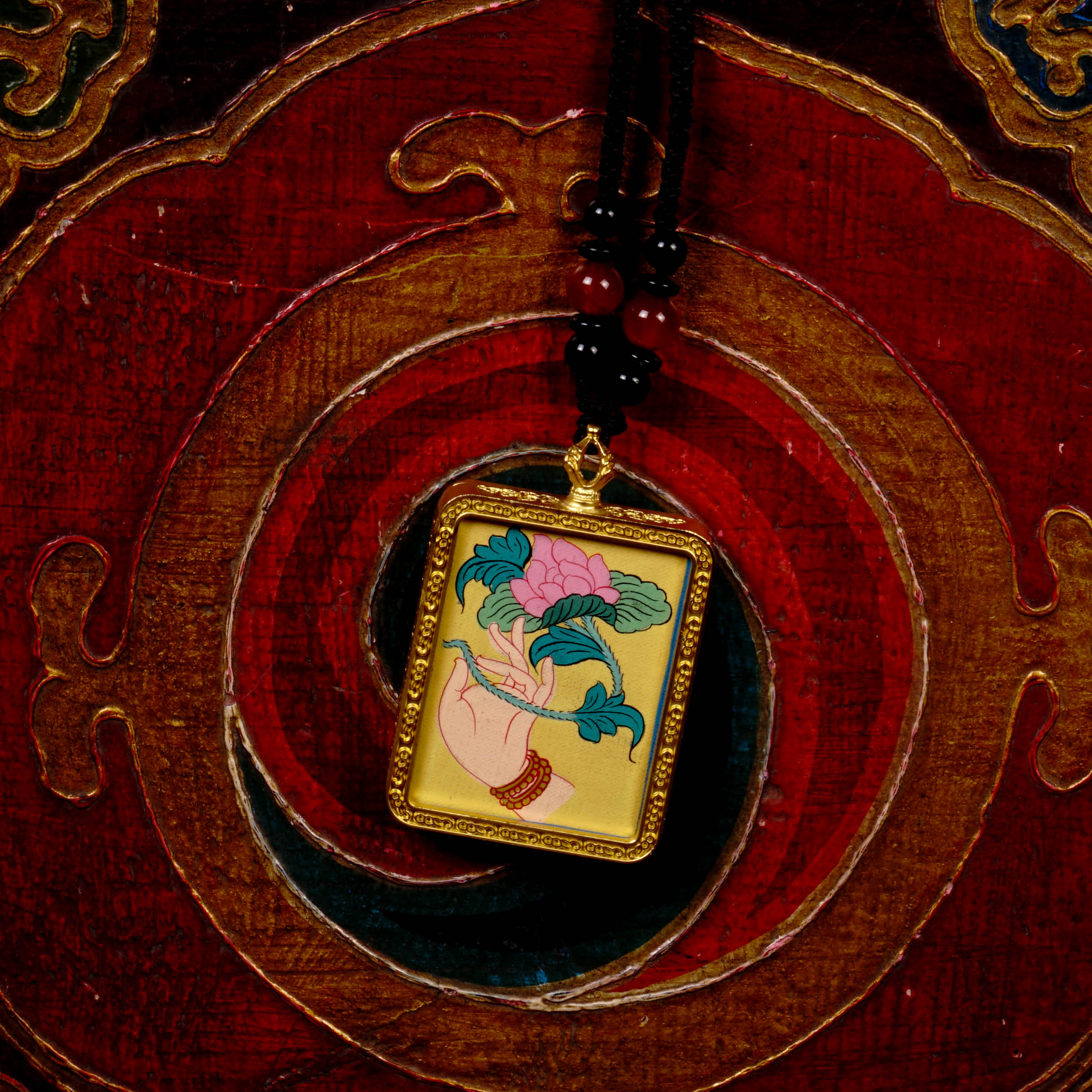 Hand-painted lotus flower in sacred hand miniature Thangka pendant inside gold-accented copper Ghau locket with black beaded cord.
