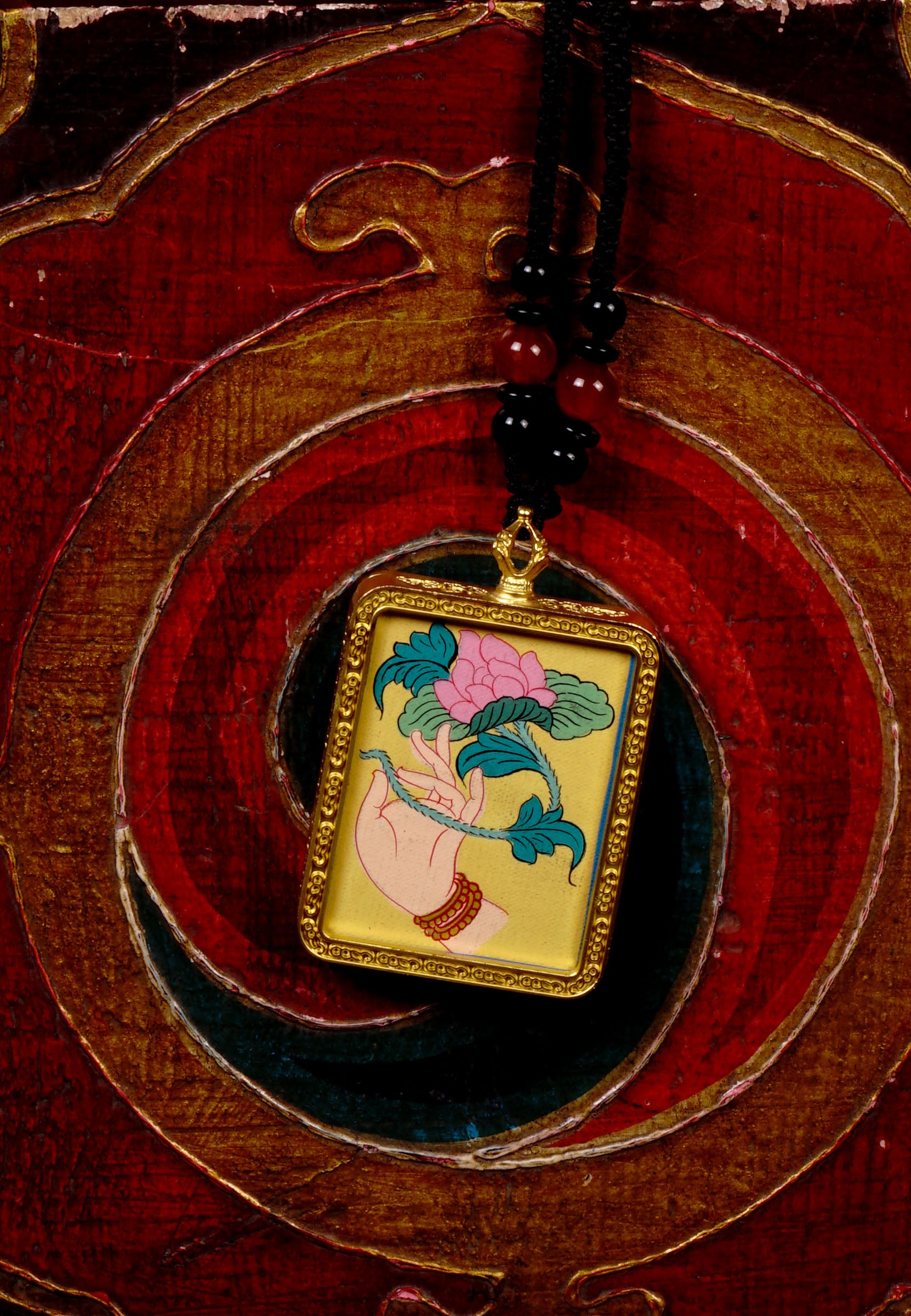 Hand-painted lotus flower in sacred hand miniature Thangka pendant inside gold-accented copper Ghau locket with black beaded cord.