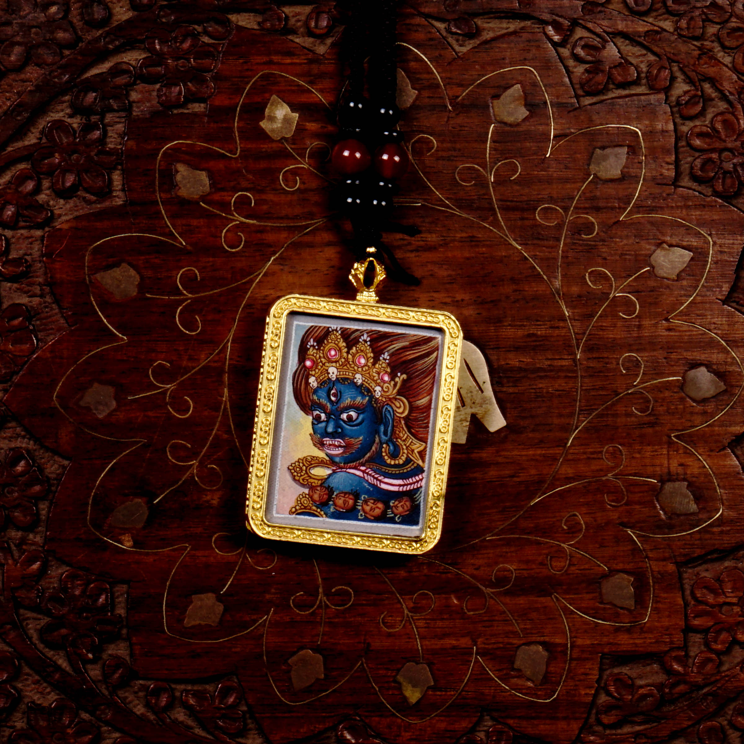 Hand-painted Mahakala miniature Thangka pendant in gold-accented copper Ghau locket with black beaded cord.