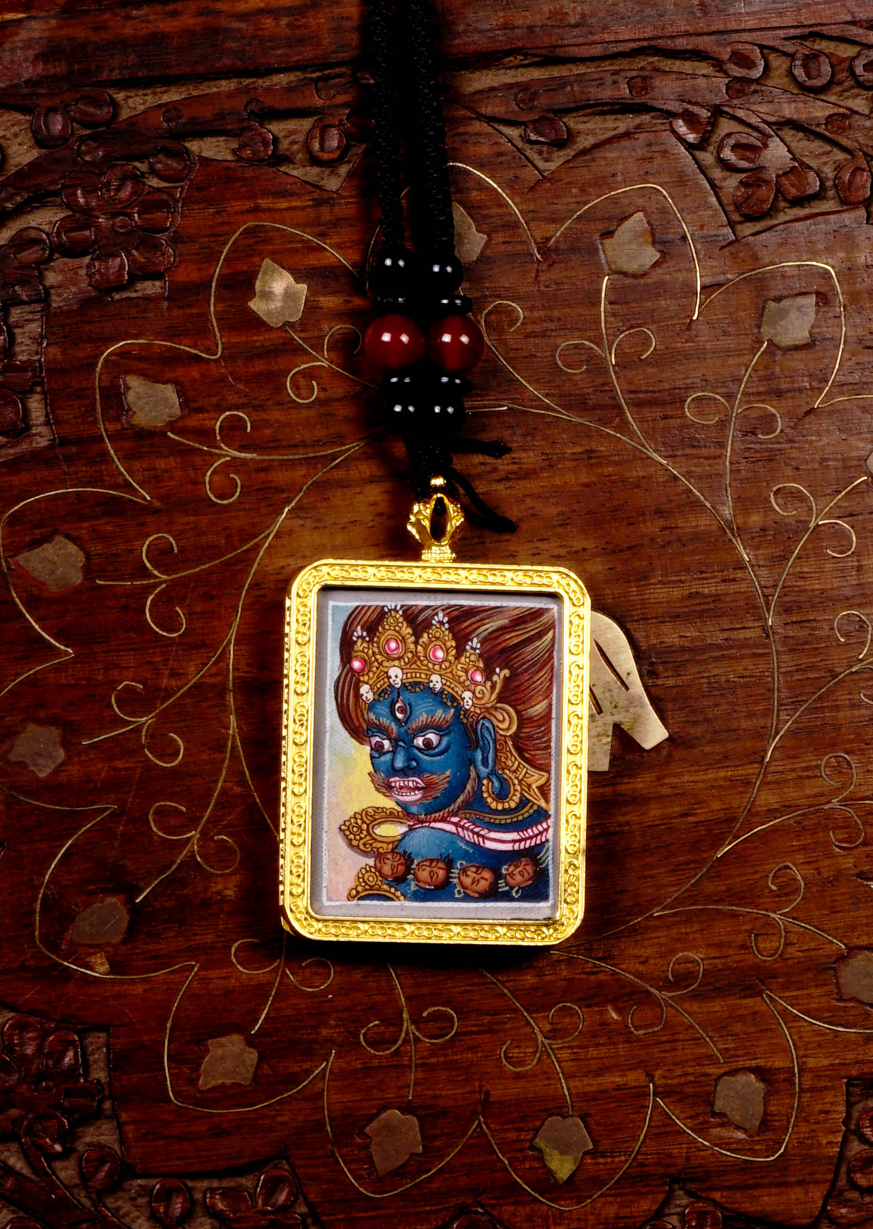 Hand-painted Mahakala miniature Thangka pendant in gold-accented copper Ghau locket with black beaded cord.