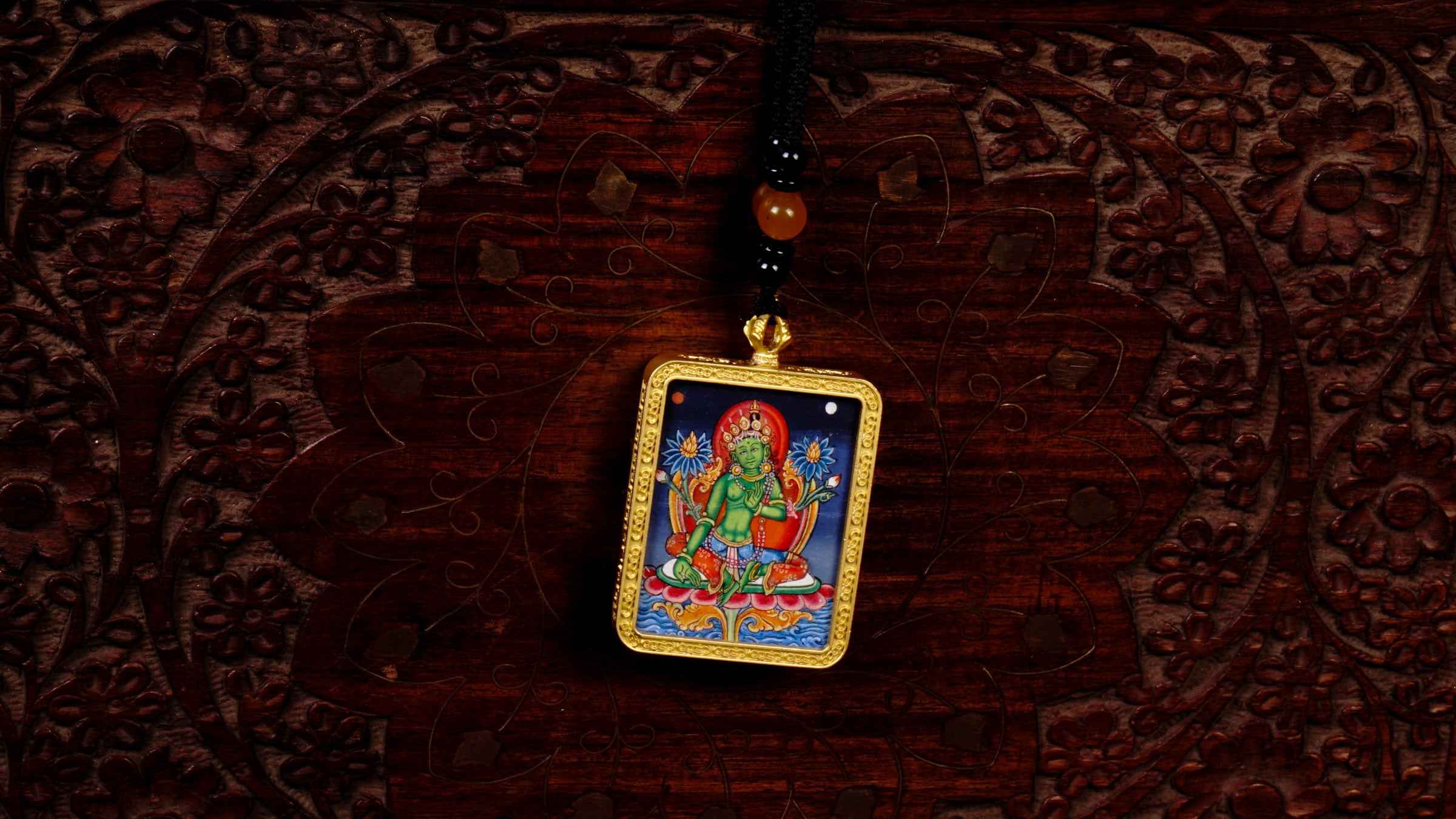 Hand-painted Green Tara miniature Thangka pendant in gold-accented copper Ghau locket with black beaded cord.