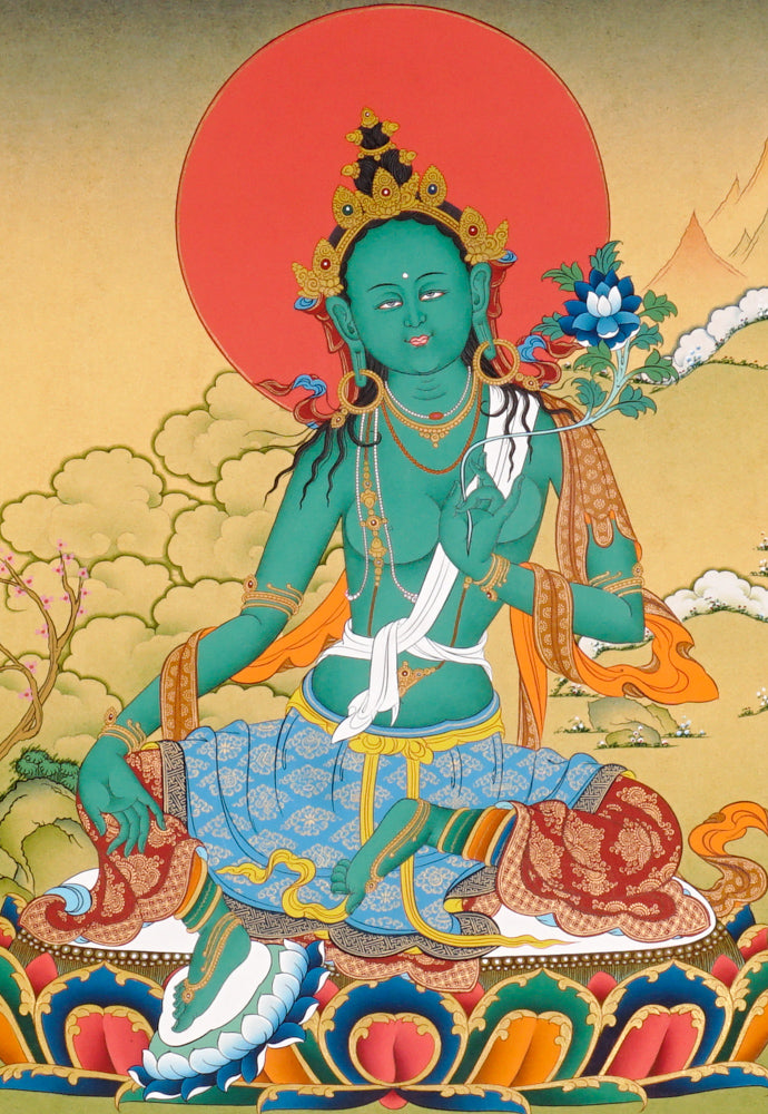 Hand-painted Green Tara thangka showing the Buddhist goddess seated on a lotus throne holding a blue utpala flower.