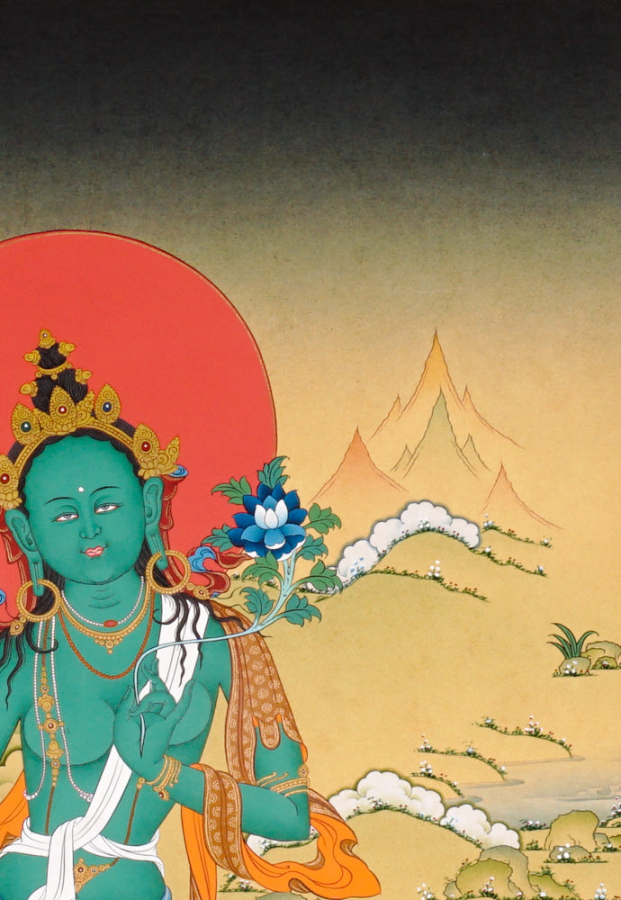 Hand-painted Green Tara thangka showing the Buddhist goddess seated on a lotus throne holding a blue utpala flower.