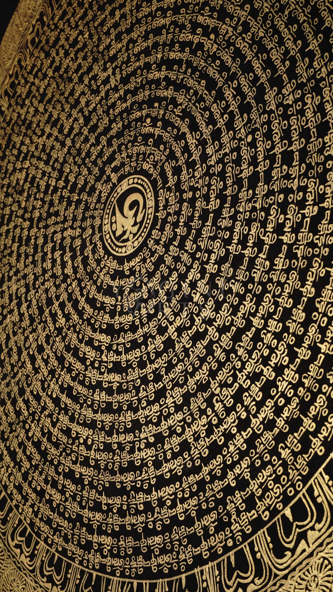 Hand-painted Tibetan Golden Mantra Mandala thangka featuring intricate sacred Tibetan calligraphy in concentric circular patterns on a black background with floral corner motifs.