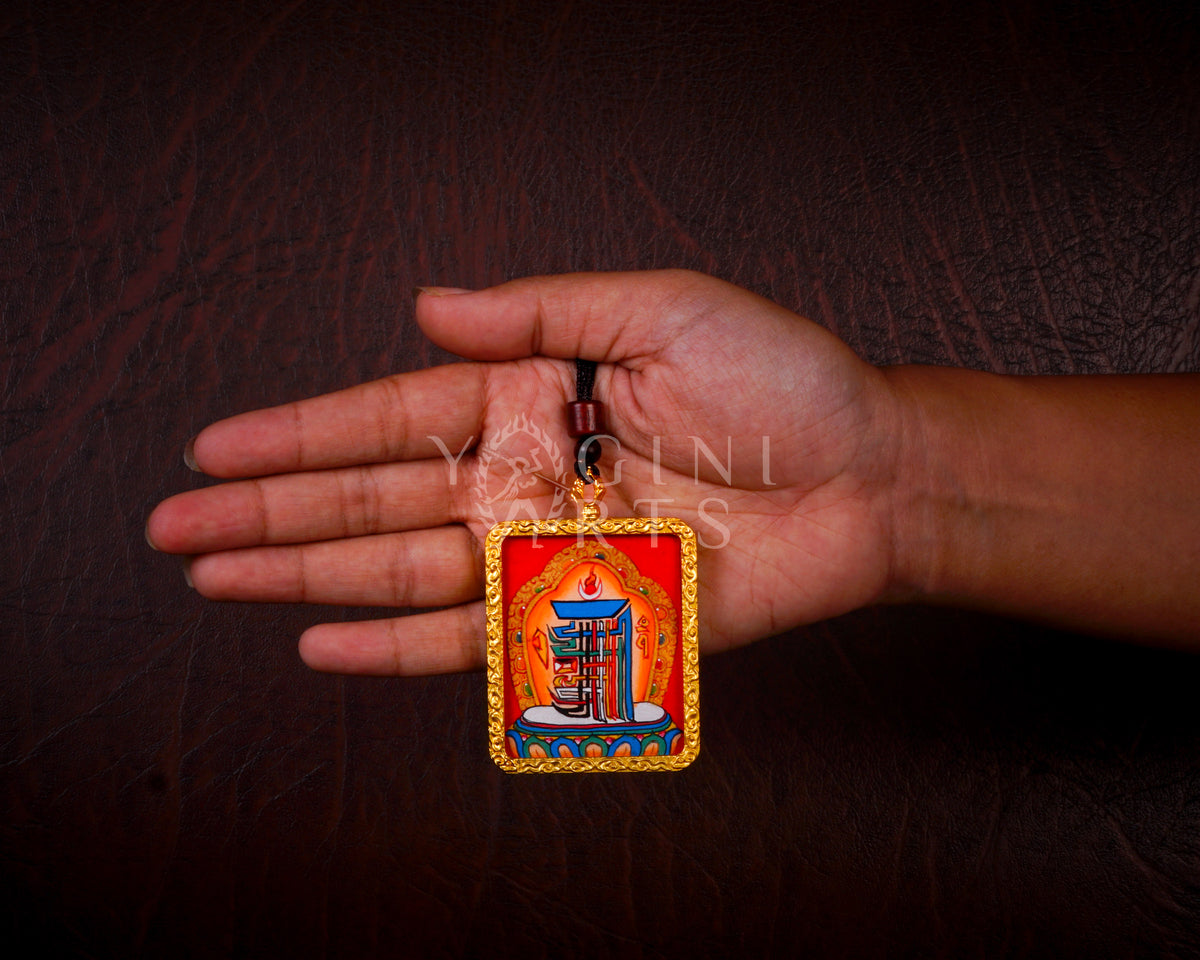 Hand-painted Kalachakra Mandala Ghau pendant in a gold-tone frame, handcrafted in Nepal using traditional Himalayan miniature painting techniques.