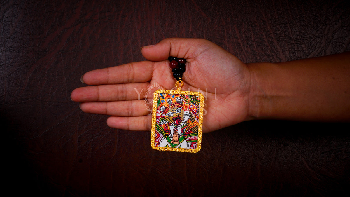 Hand-painted Zhaji Lhamo Ghau pendant in a gold-tone frame, handcrafted in Nepal using traditional Himalayan miniature painting techniques.