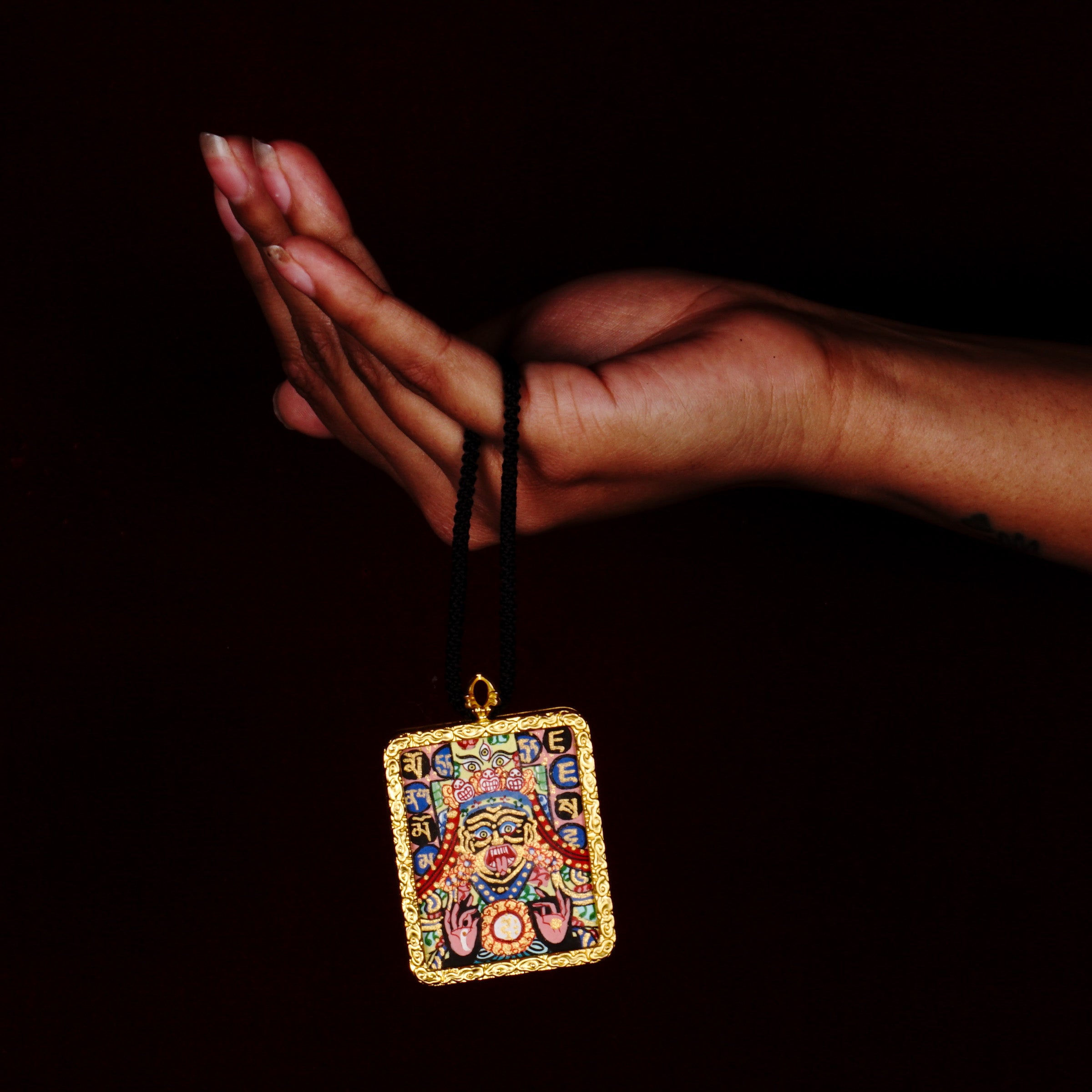 Hand-painted Goddess Kali miniature Thangka pendant in gold-accented copper Ghau locket with black cord.