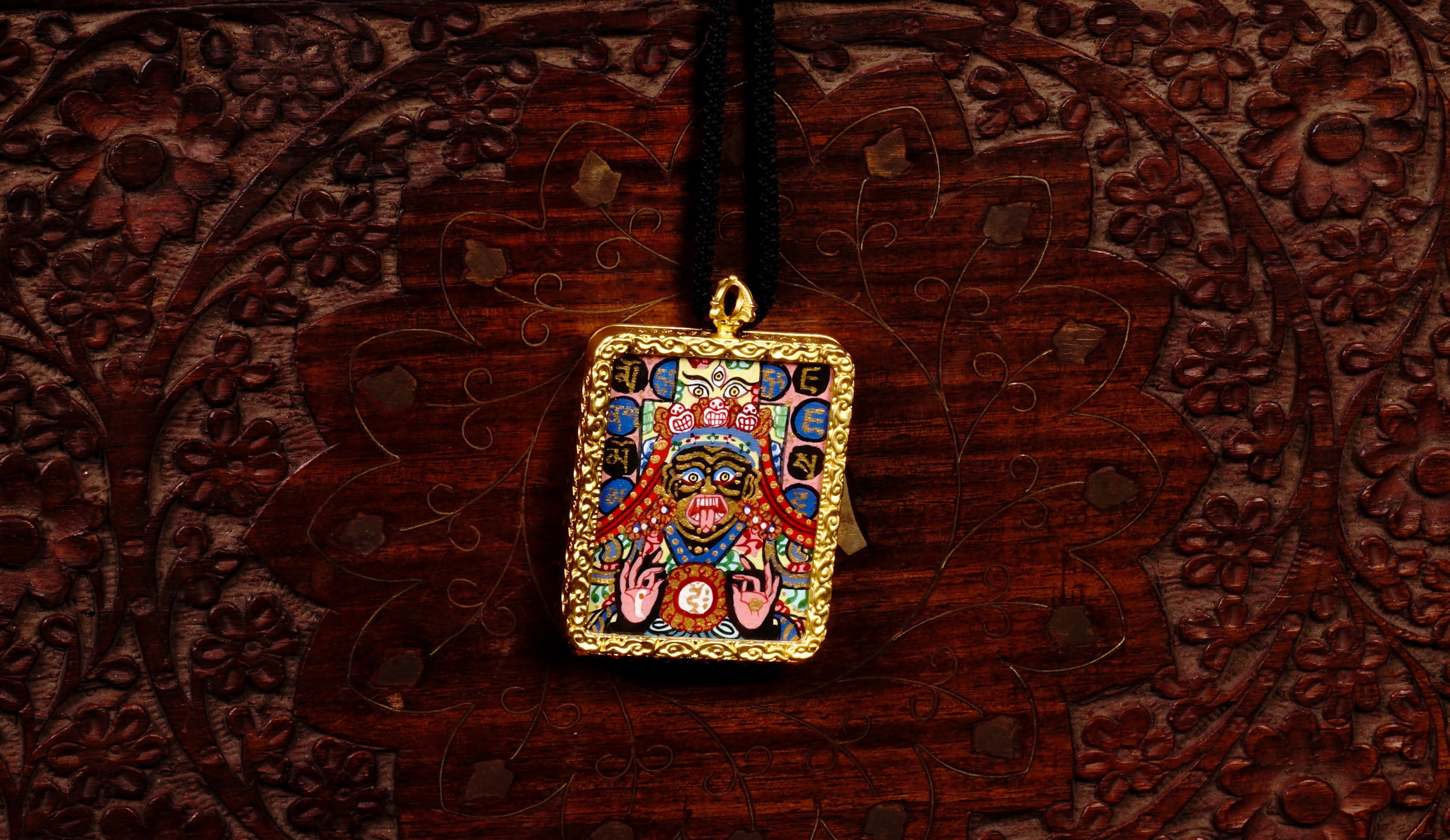 Hand-painted Goddess Kali miniature Thangka pendant in gold-accented copper Ghau locket with black cord.