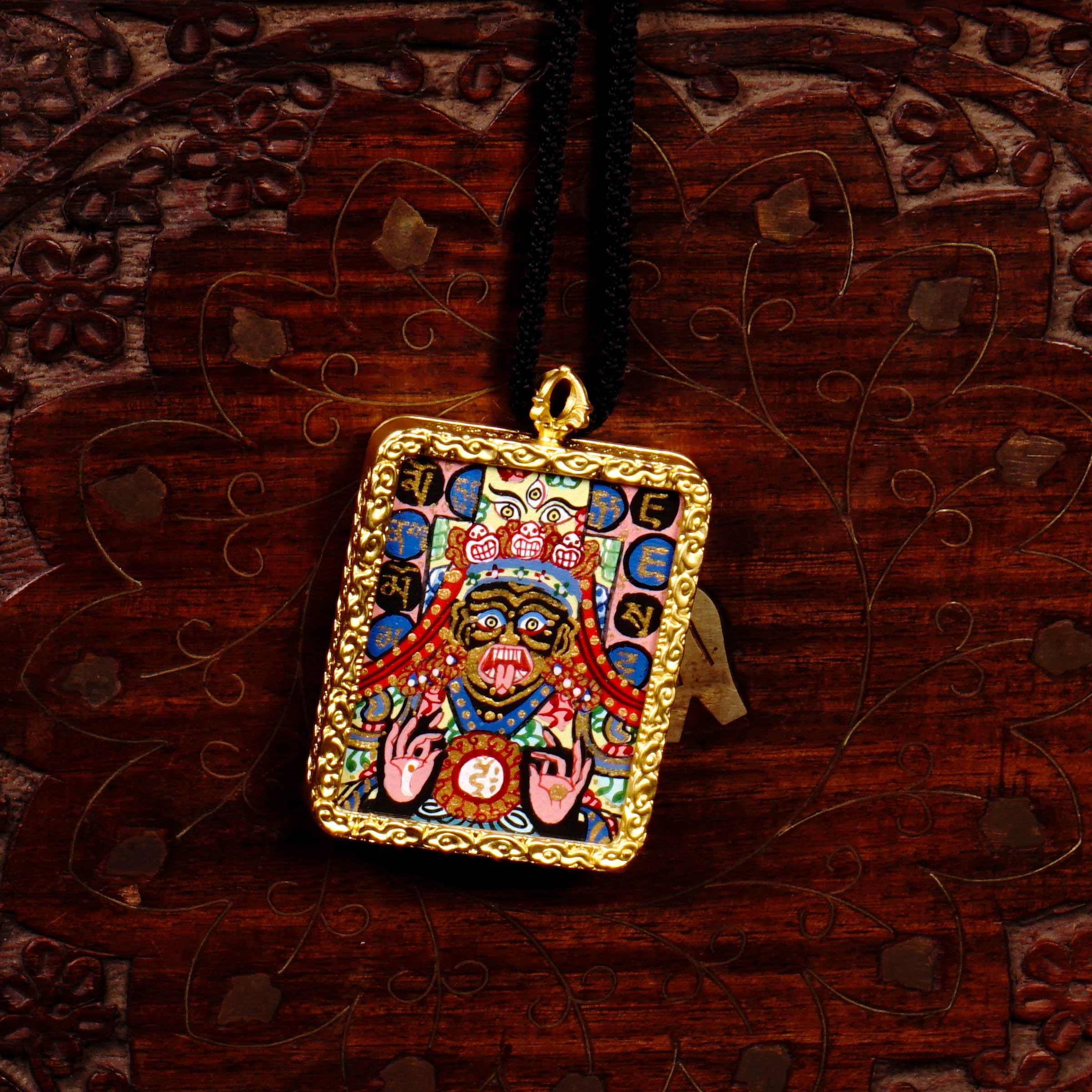 Hand-painted Goddess Kali miniature Thangka pendant in gold-accented copper Ghau locket with black cord.