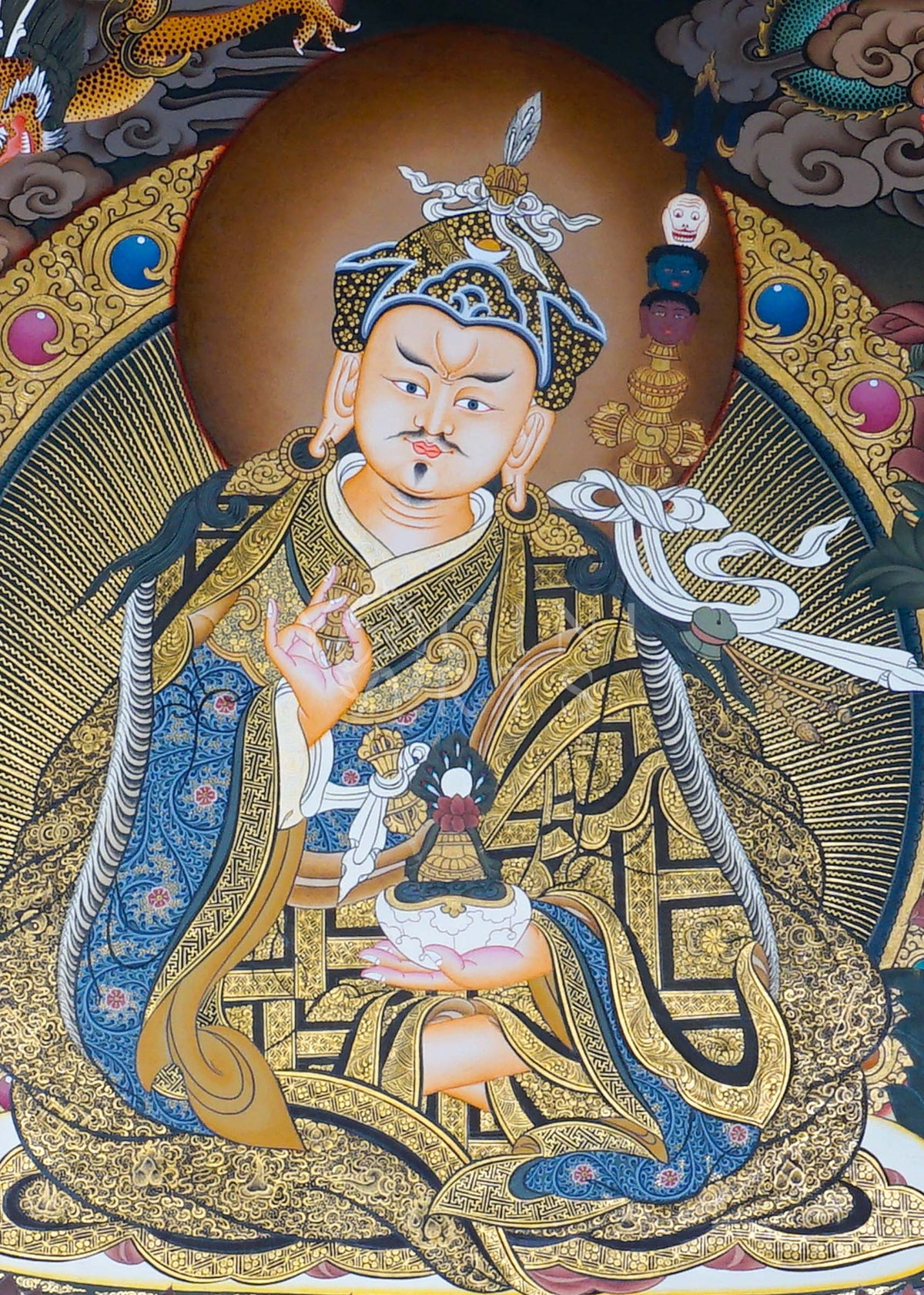 Hand-painted Guru Rinpoche Thangka featuring Guru Padmasambhava with White Tara and Amitayus, natural mineral pigments, gold detailing, and a traditional Himalayan landscape.