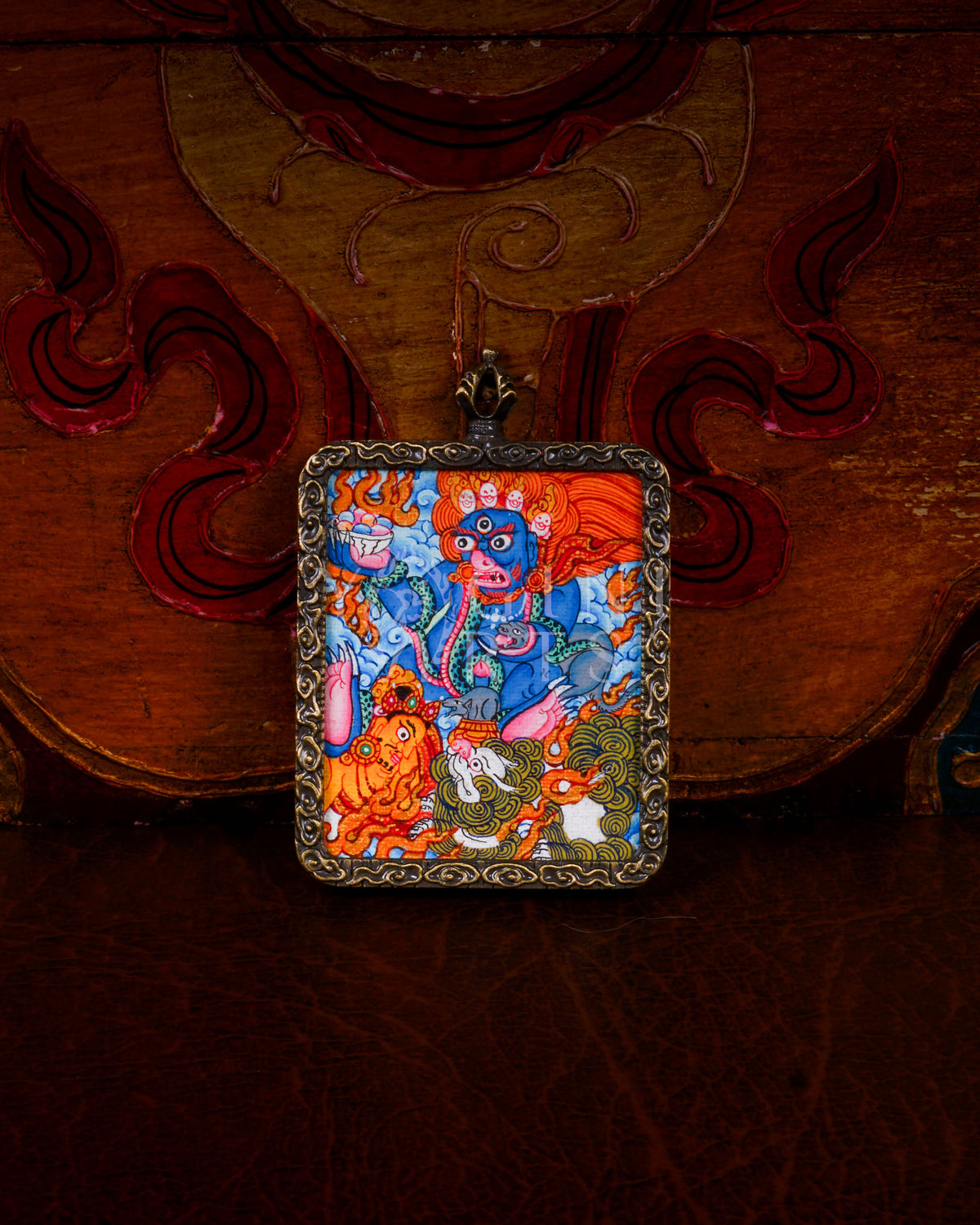 Hand-painted Black Zambhala Ghau pendant in an antique-style metal frame, handcrafted in Nepal using traditional Tibetan miniature painting techniques.