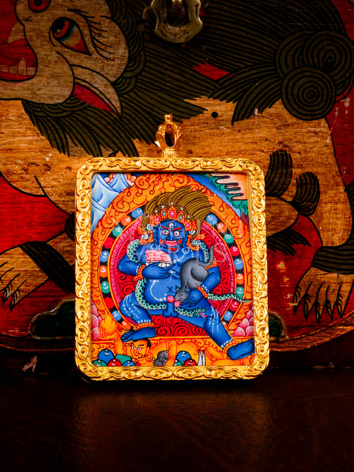 Hand-painted Black Zambhala Ghau pendant in a gold-tone frame, handcrafted in Nepal using traditional Tibetan miniature painting techniques.