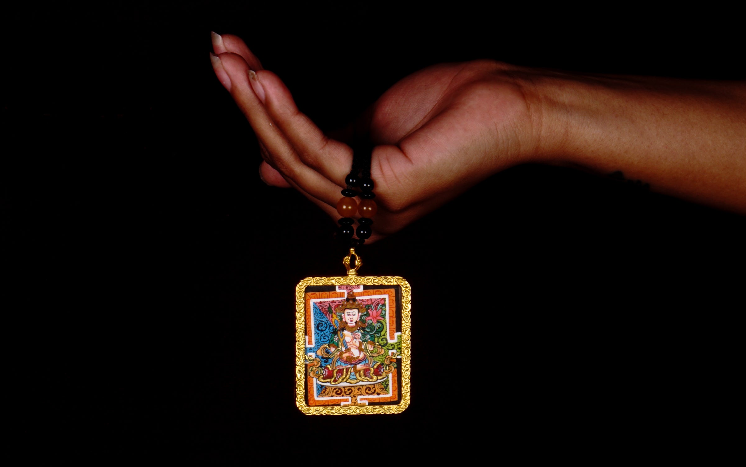 Hand-painted Fushen Fusa miniature Thangka pendant in gold-accented copper Ghau locket with black beaded cord.