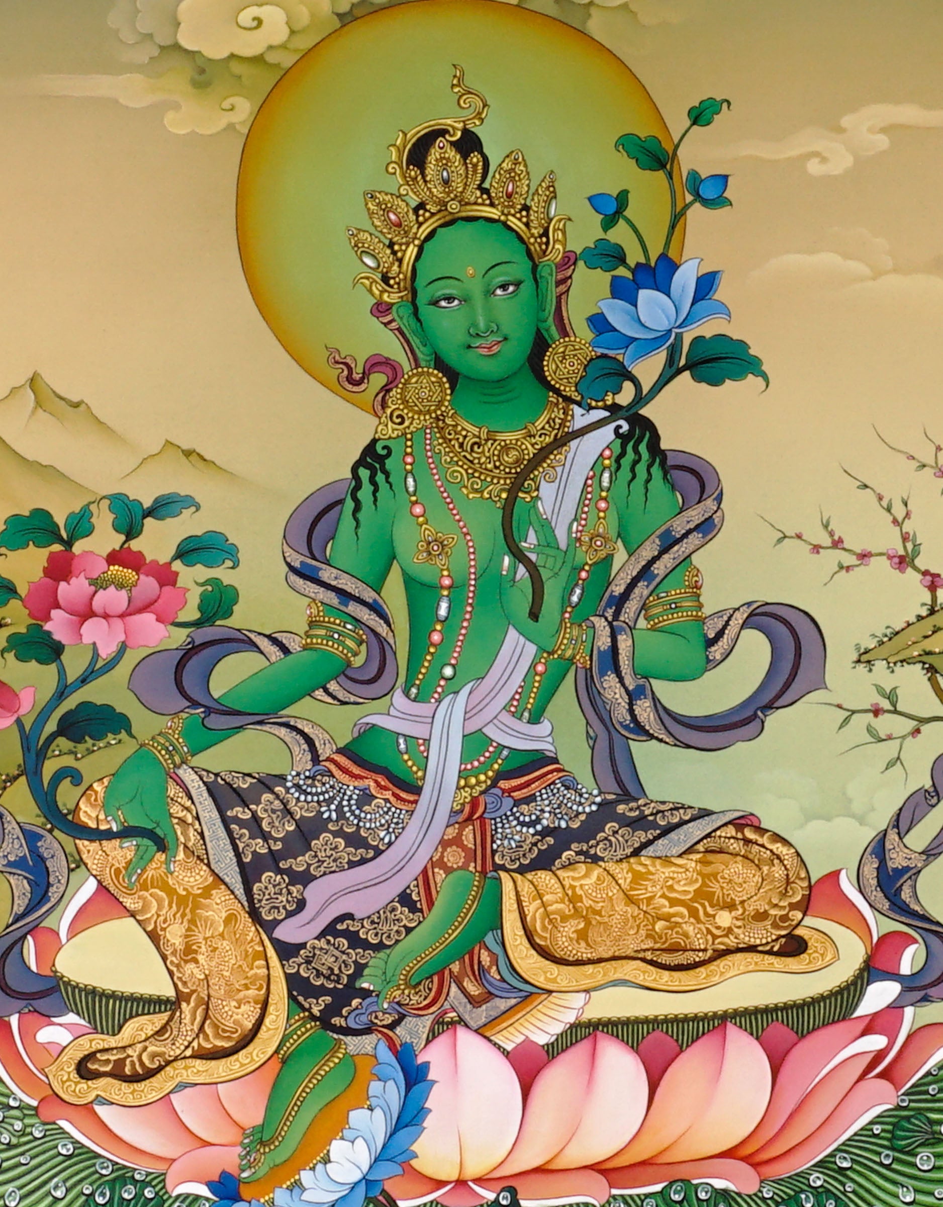 Hand-painted Green Tara thangka showing Tibetan Buddhist goddess seated on lotus throne holding blue utpala lotus, with Amitabha above and Himalayan landscape background.