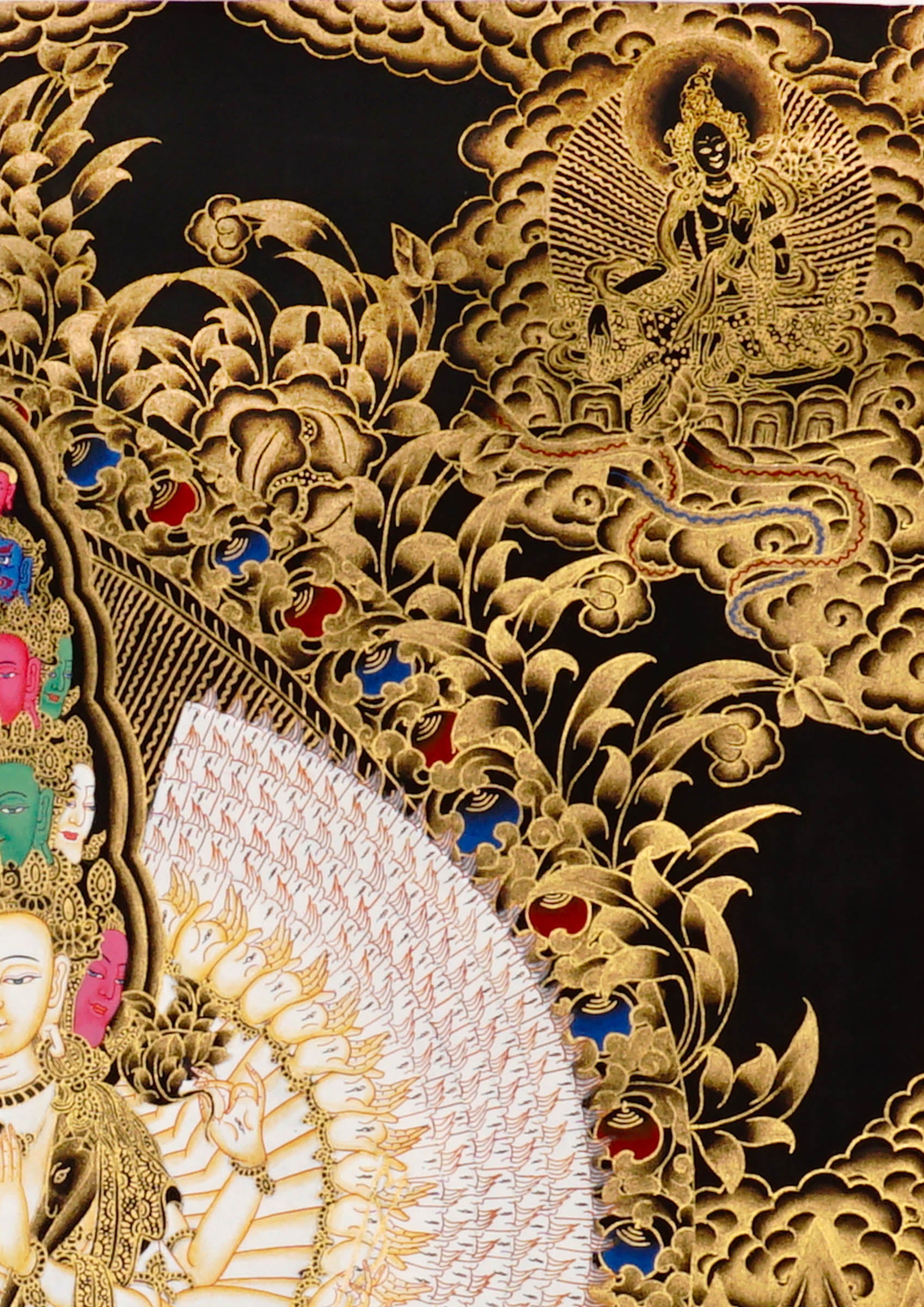 Hand-painted Thousand-Armed Avalokiteshvara thangka in gold on black background showing eleven-faced Chenrezig with multiple arms standing on lotus pedestal.