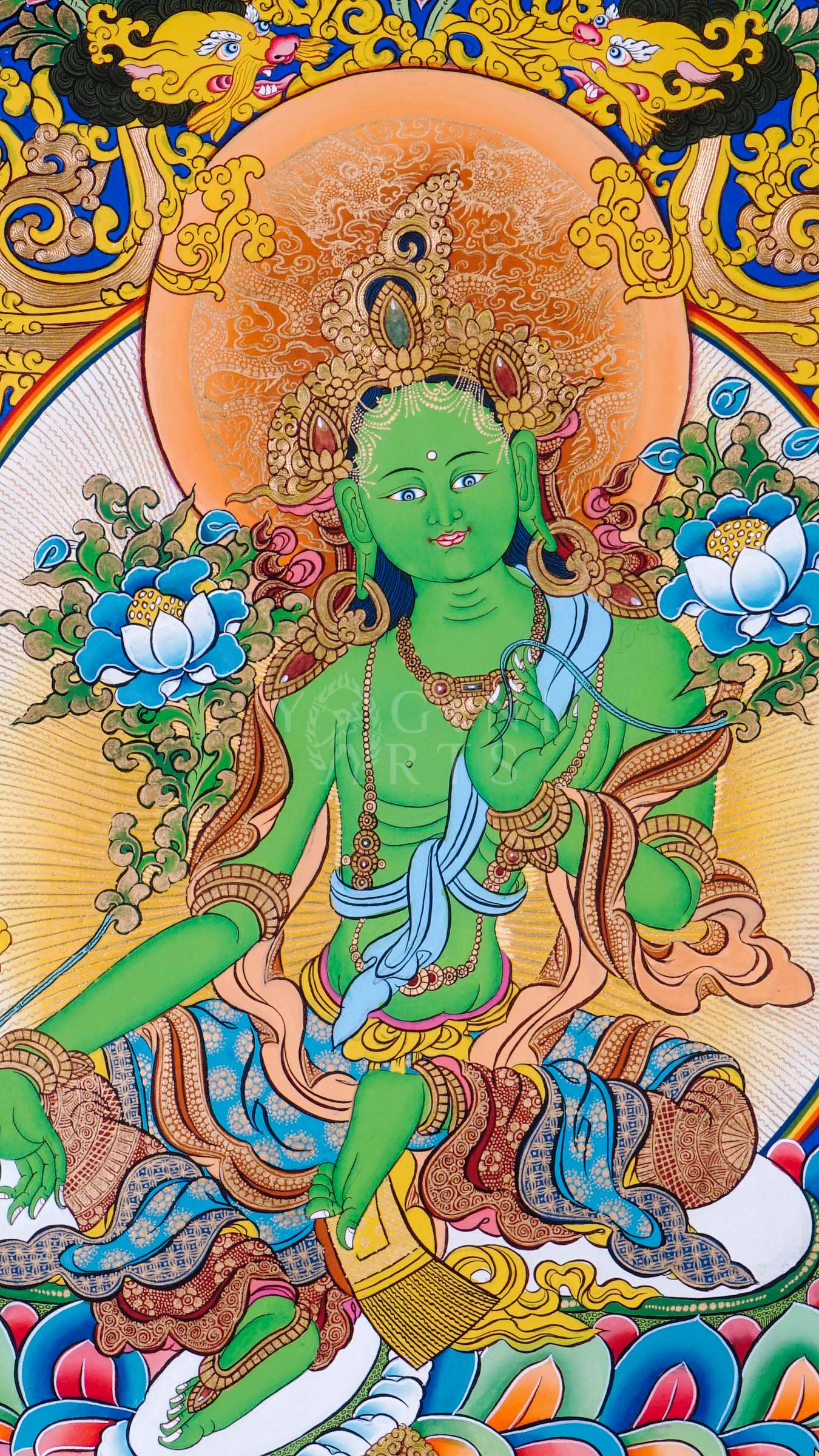 Green Tara seated on a lotus throne surrounded by sacred floral motifs and traditional Himalayan Buddhist ornamentation.