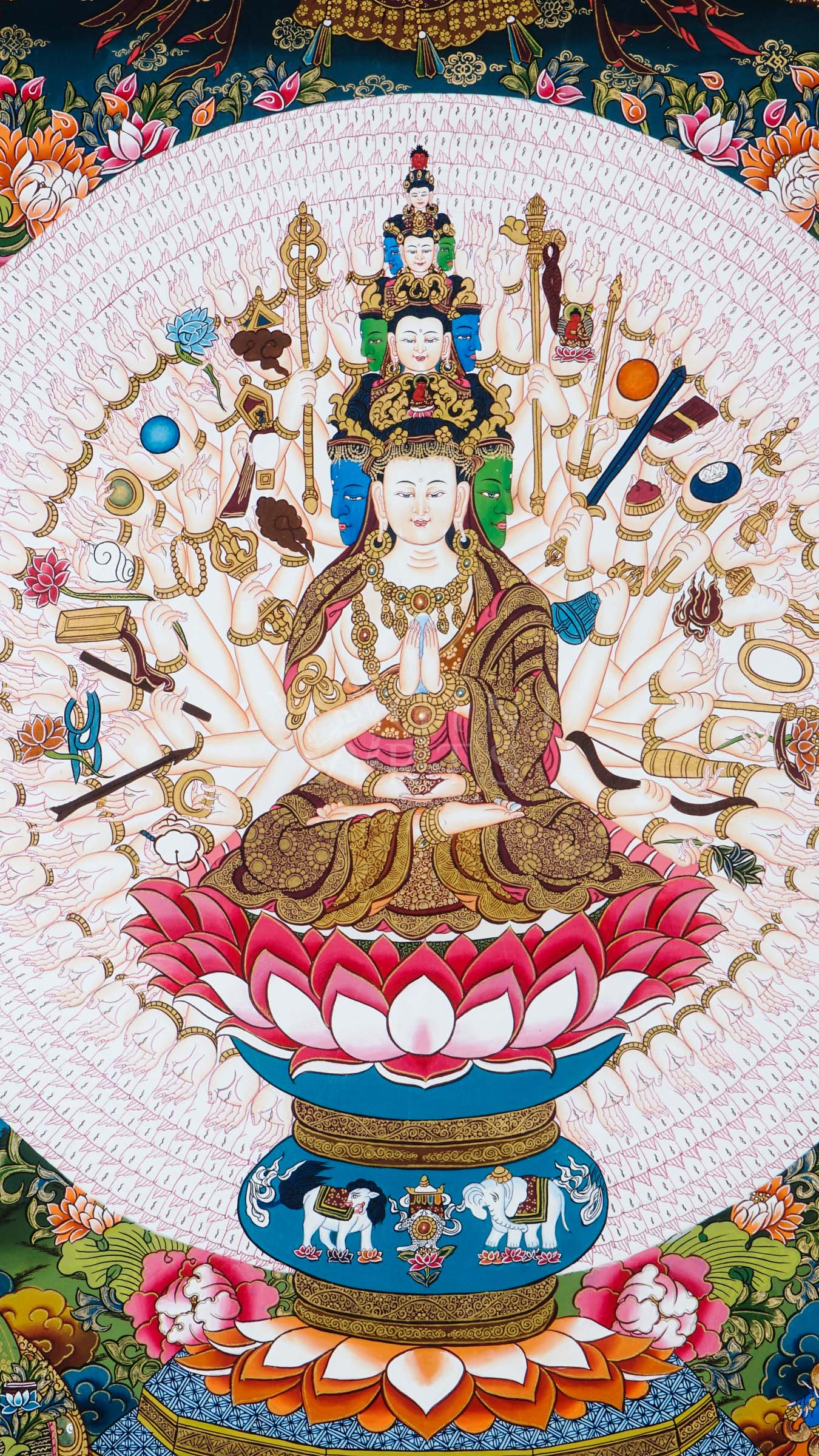 Hand-painted Tibetan thangka of Thousand-Armed Avalokiteshvara seated on a lotus throne surrounded by countless sacred arms, ritual implements, and traditional Himalayan Buddhist ornamentation.