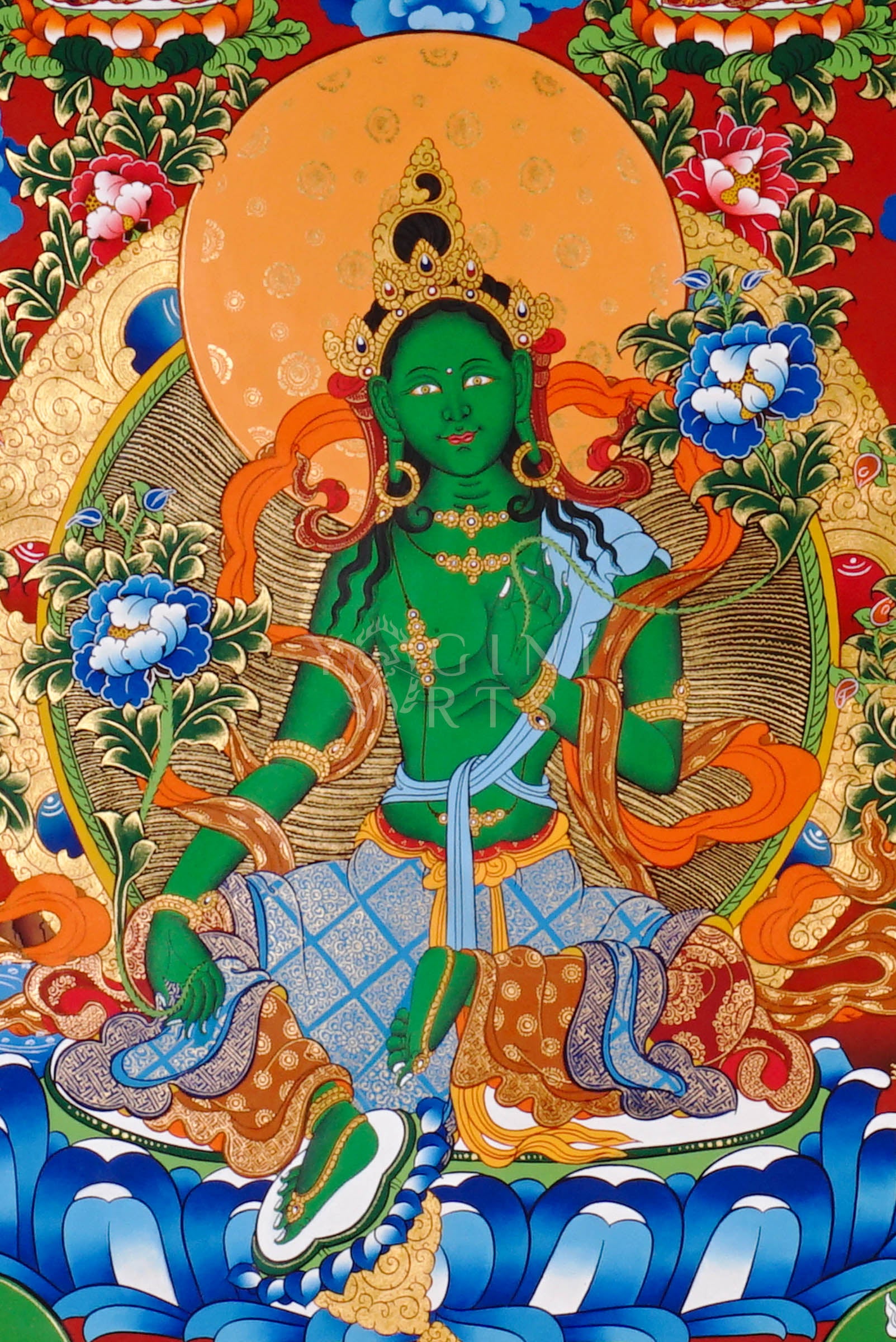 Green Tara thangka featuring the bodhisattva seated on a lotus throne with lotus flowers, surrounded by celestial figures and vibrant Himalayan landscape.