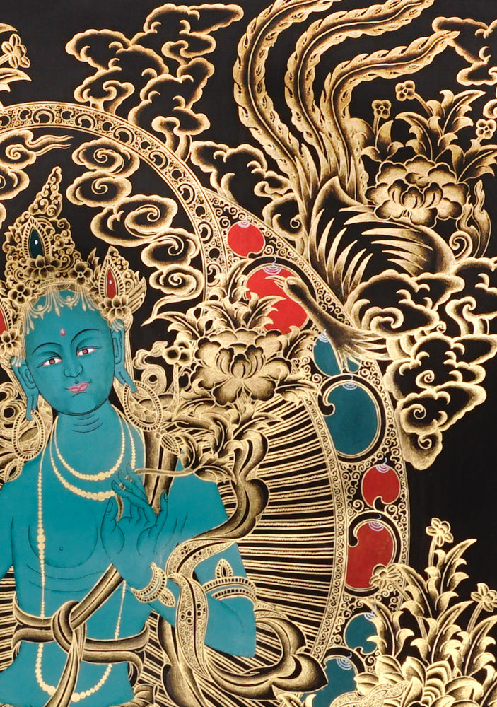 Gold-on-black Green Tara thangka showing the Buddhist goddess seated on a lotus throne surrounded by intricate gold floral and bird motifs.