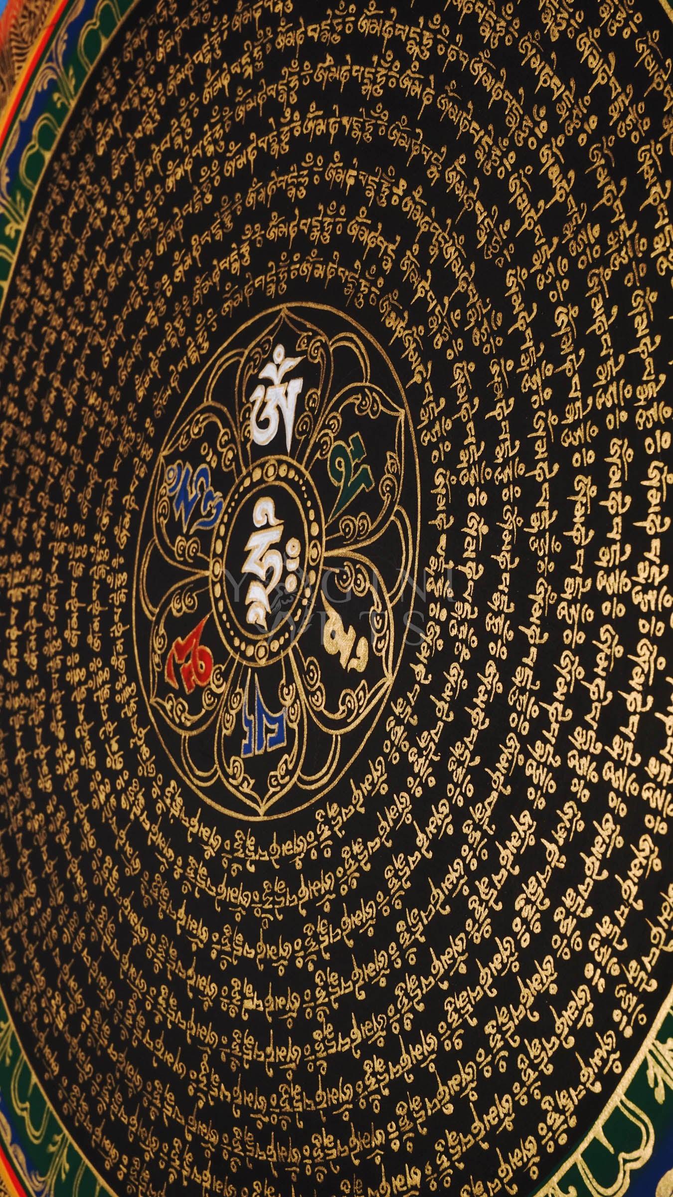 Black background Tibetan mantra mandala thangka with gold concentric script circles and central sacred syllable.