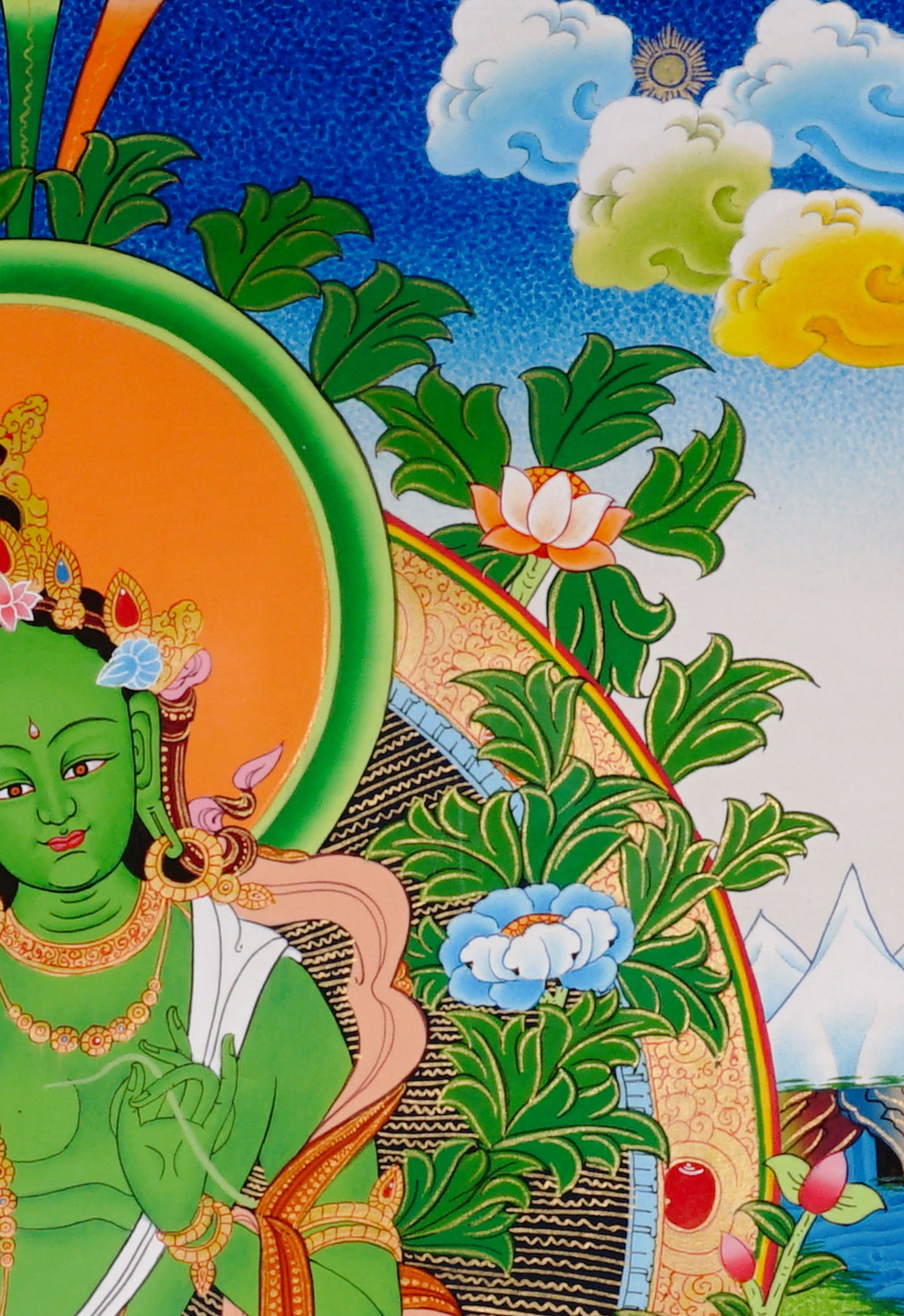Green Tara thangka featuring the Tibetan Buddhist goddess seated on a lotus throne surrounded by flowers and sacred Himalayan landscape