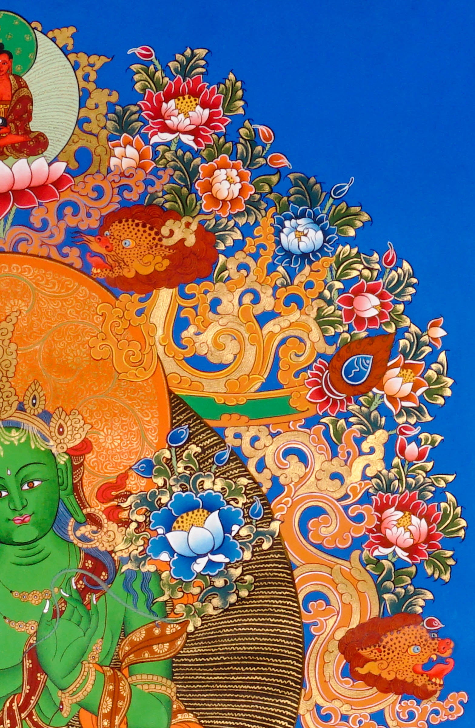 Hand-painted Green Tara thangka featuring the Tibetan Buddhist goddess seated on a lotus throne surrounded by sacred floral motifs and celestial symbolism