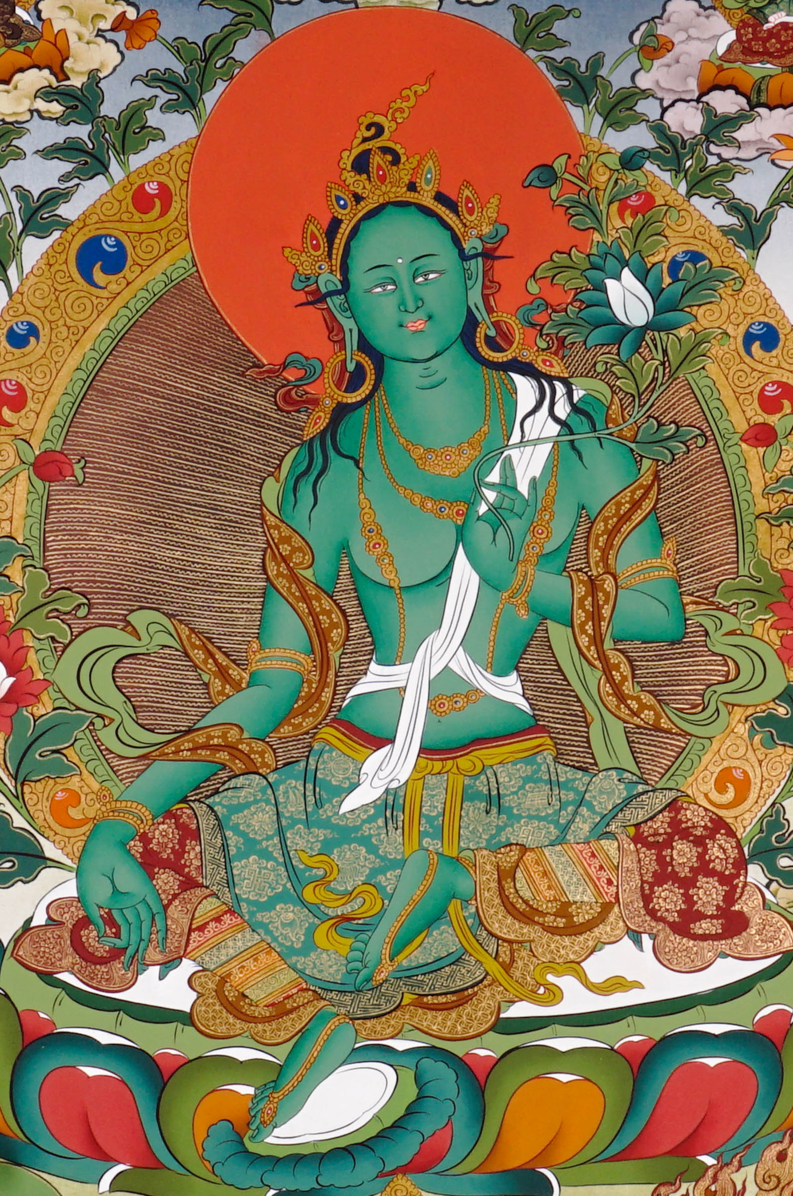 Hand-painted Tibetan Green Tara thangka featuring the Buddhist goddess seated on a lotus throne surrounded by sacred deities and floral Himalayan scenery