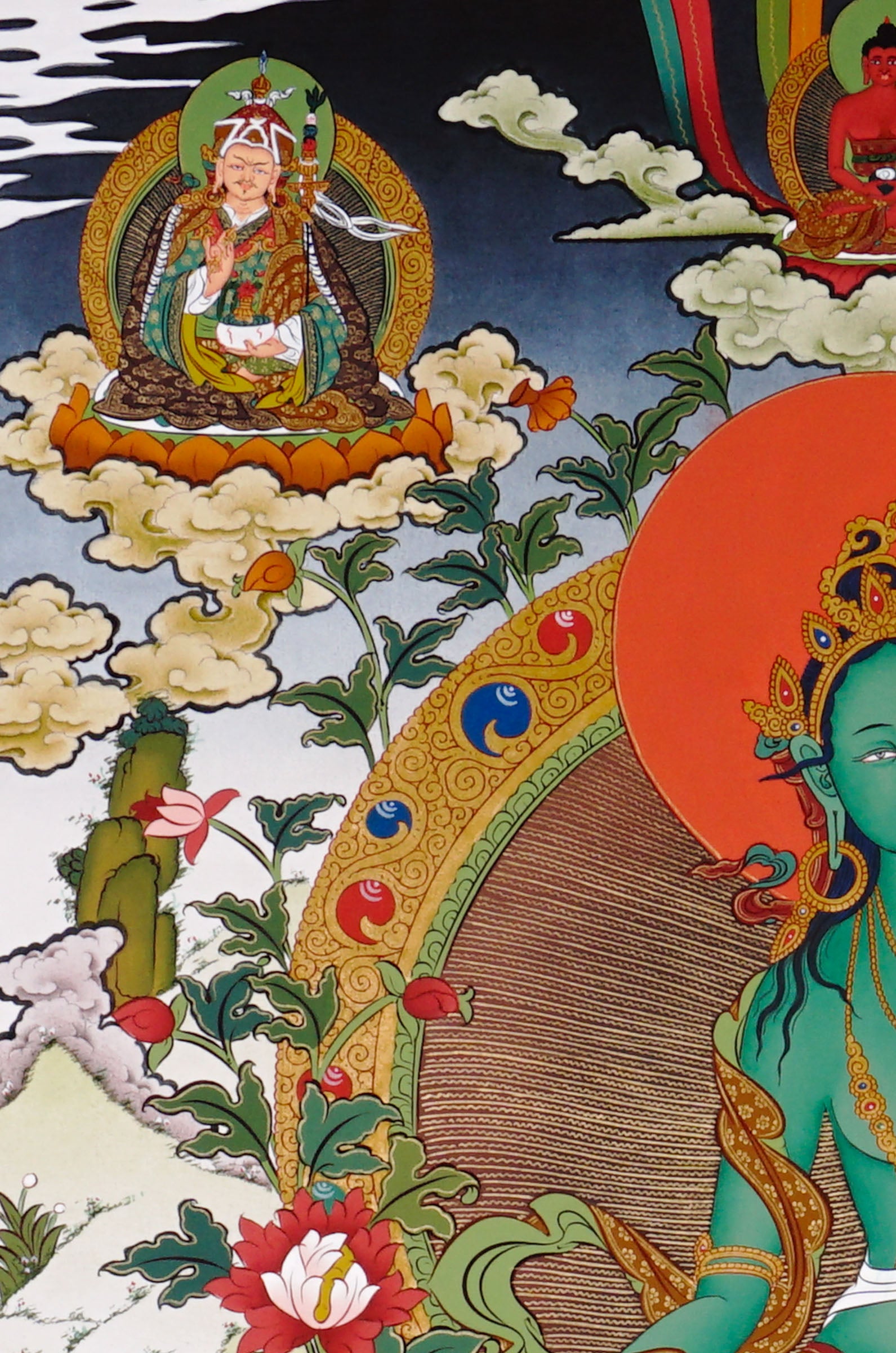 Hand-painted Tibetan Green Tara thangka featuring the Buddhist goddess seated on a lotus throne surrounded by sacred deities and floral Himalayan scenery