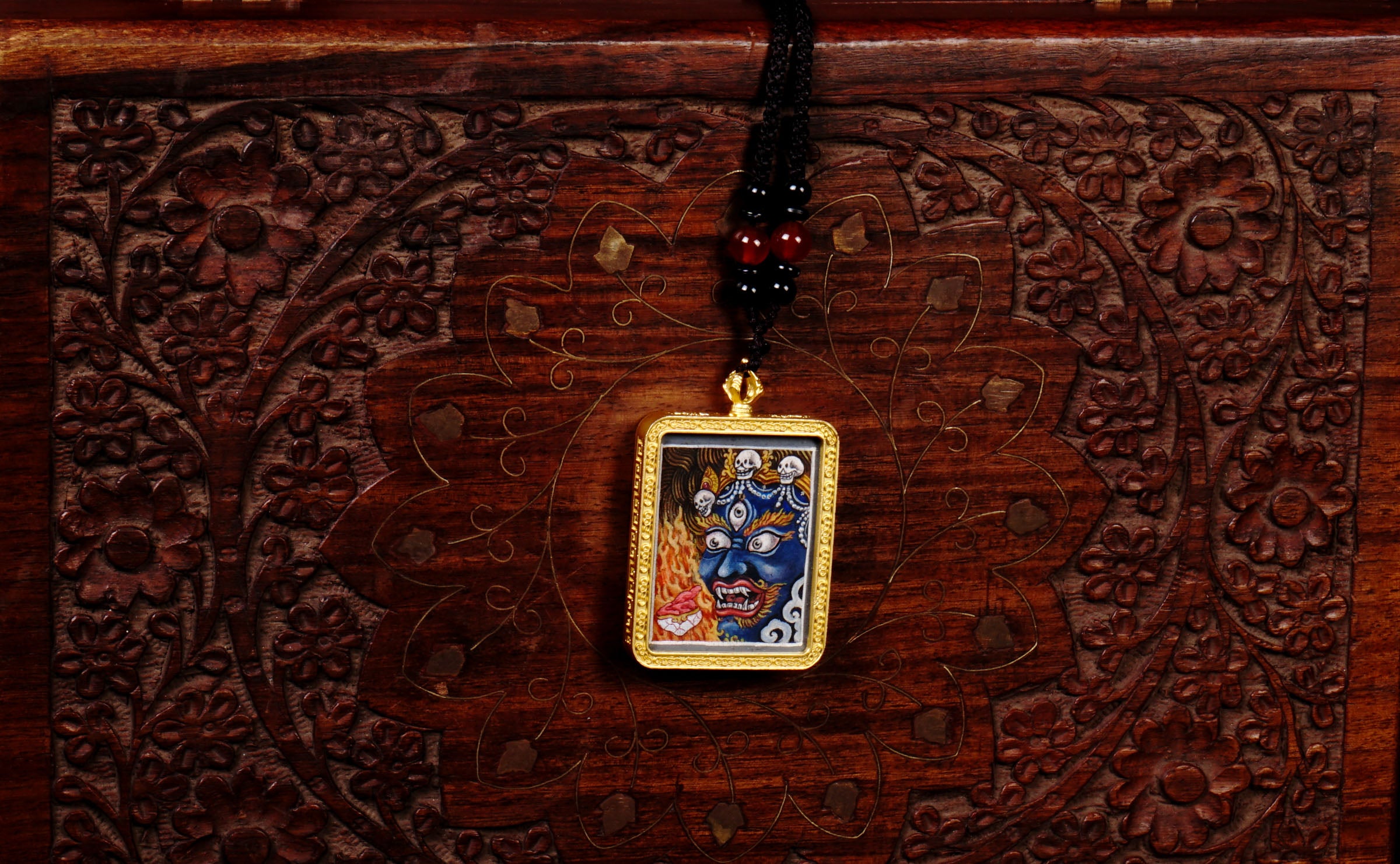 Hand-painted Mahakala miniature Thangka pendant in gold-accented copper Ghau locket with black beaded cord.