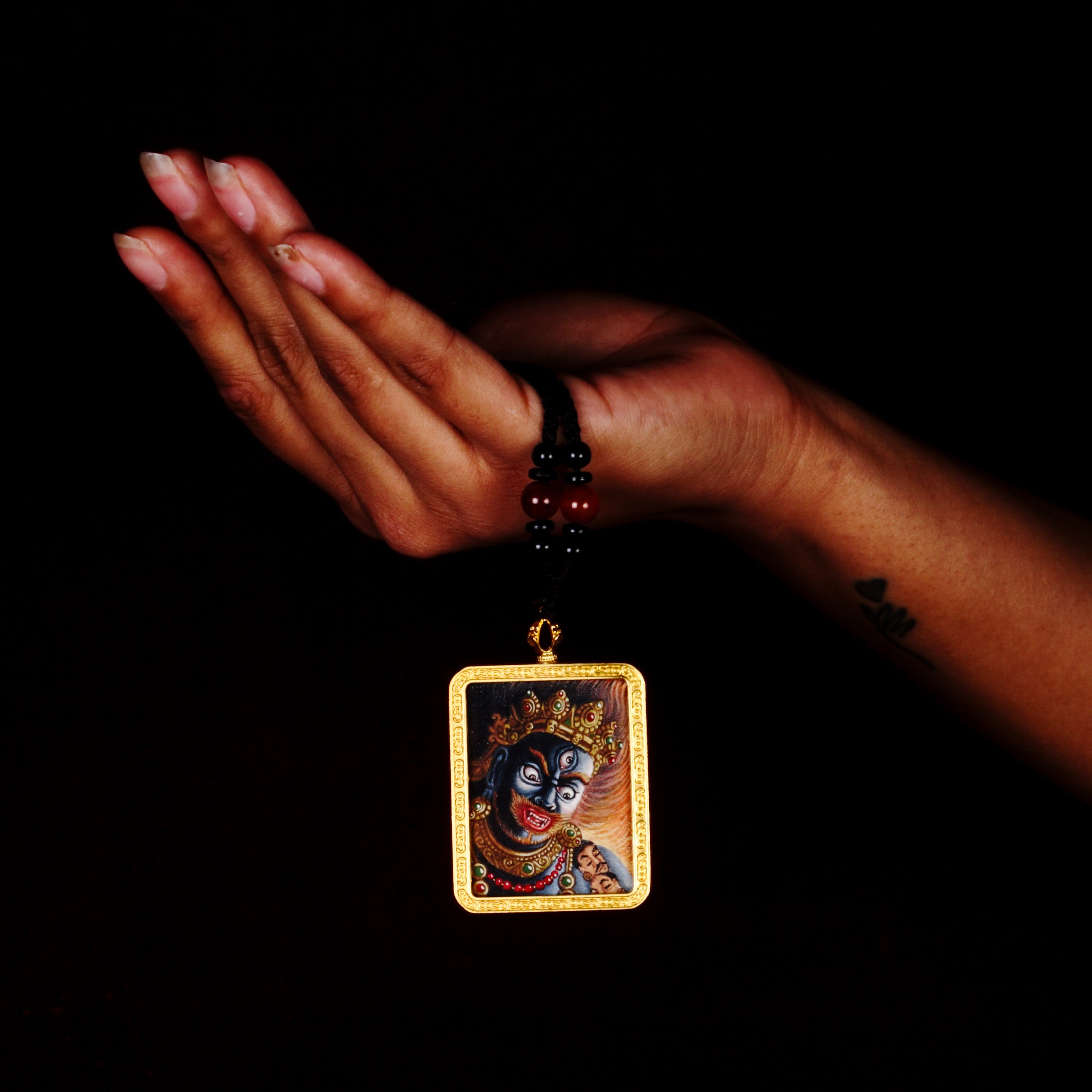 Hand-painted Mahakala miniature Thangka pendant in gold-accented copper Ghau locket with black beaded cord.