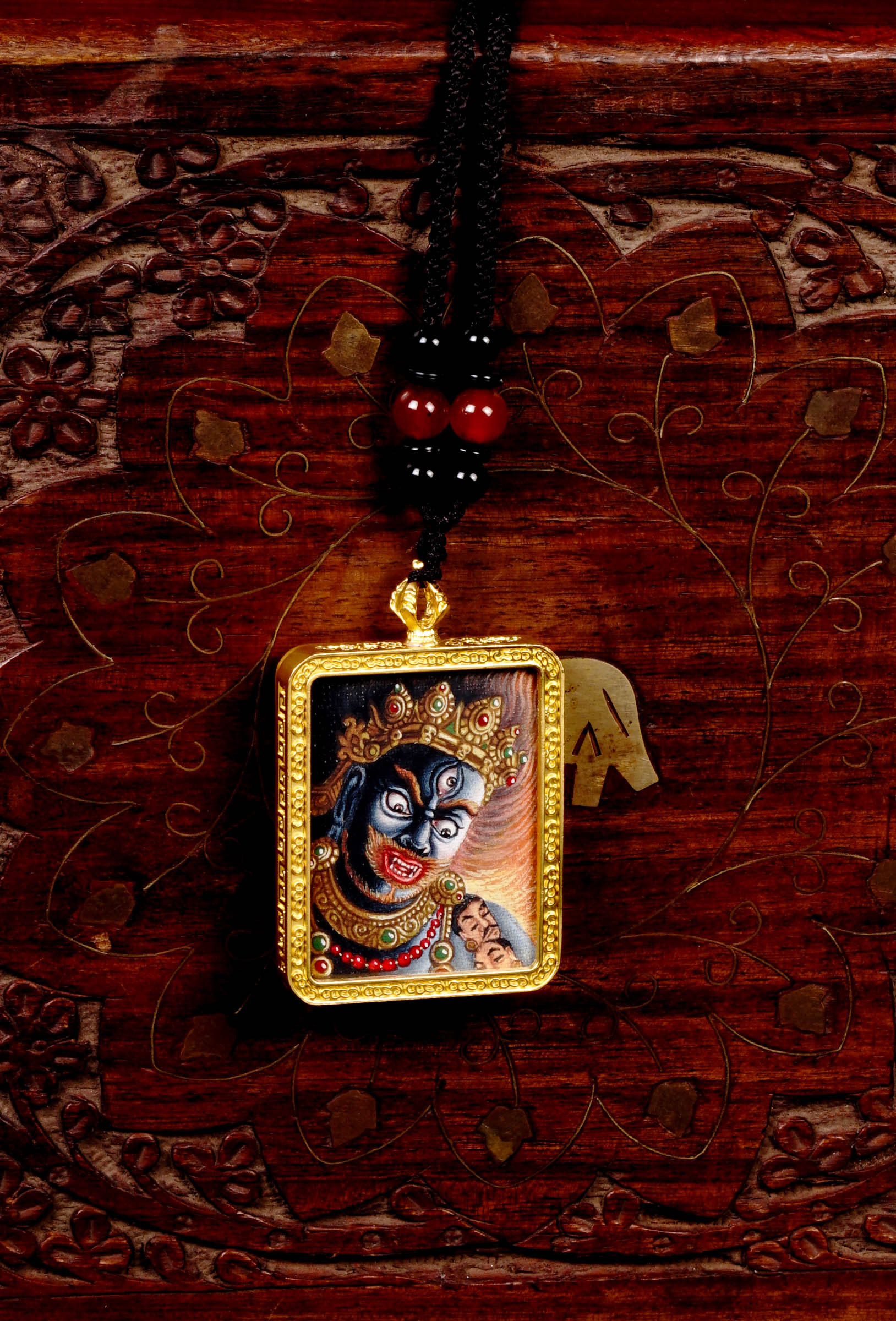 Hand-painted Mahakala miniature Thangka pendant in gold-accented copper Ghau locket with black beaded cord.