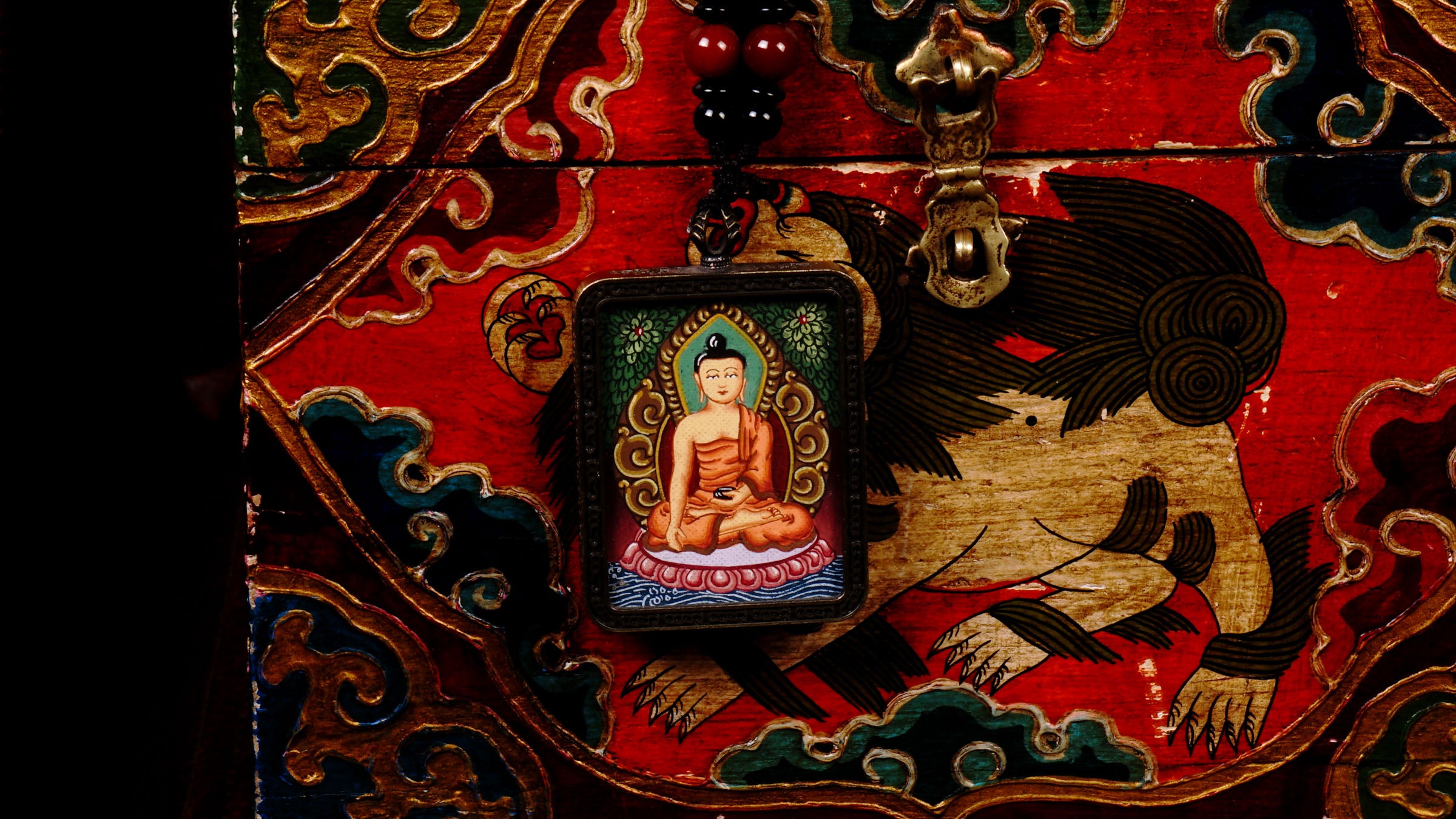 Hand-painted Shakyamuni Buddha miniature Thangka pendant in gold-accented copper Ghau locket with black beaded cord.