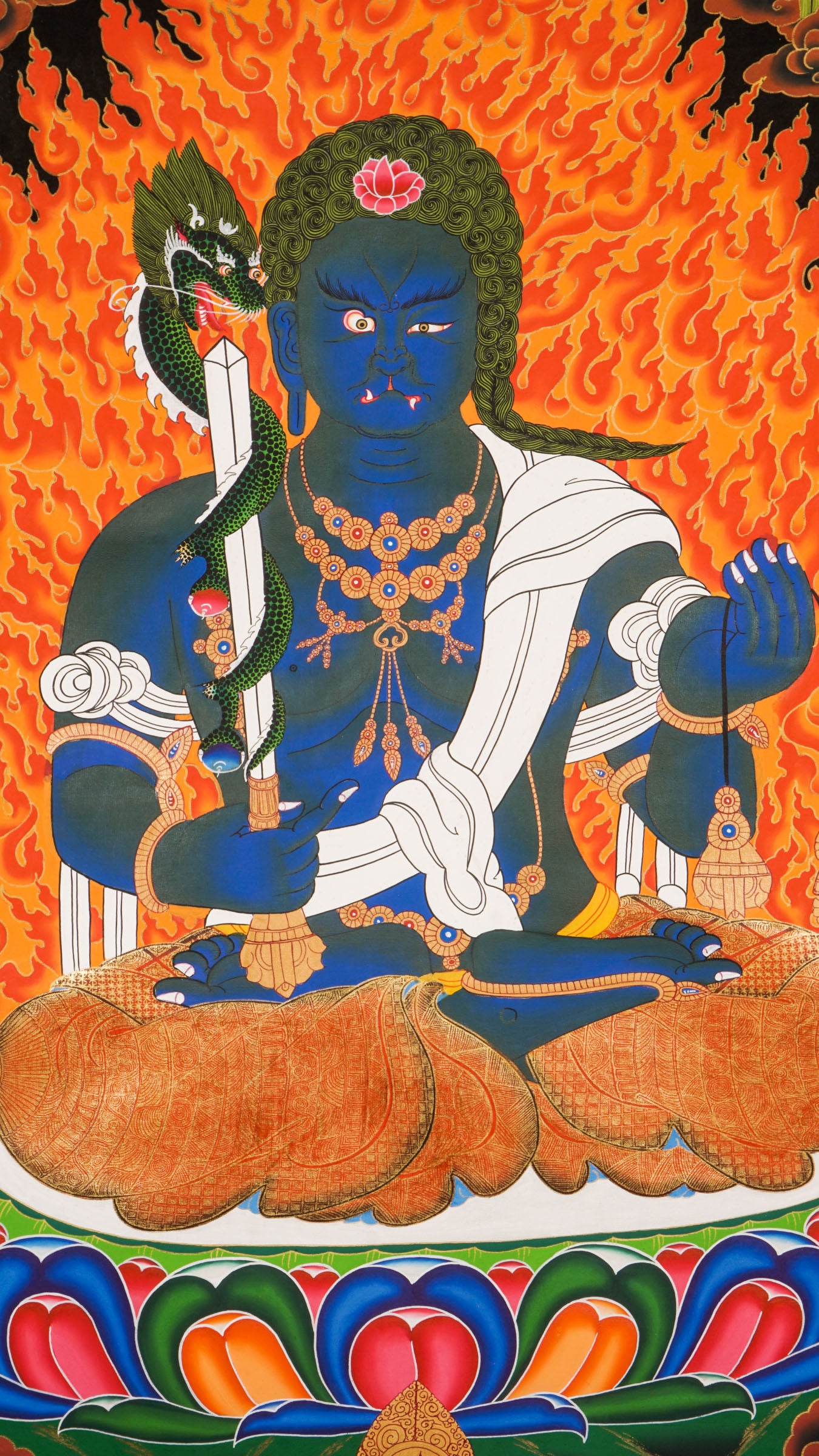 Traditional Tibetan thangka painting depicting Yamaraj, a blue-skinned wrathful deity seated on a lotus throne, surrounded by blazing flames, clouds, and symbolic ornaments against a dark background.