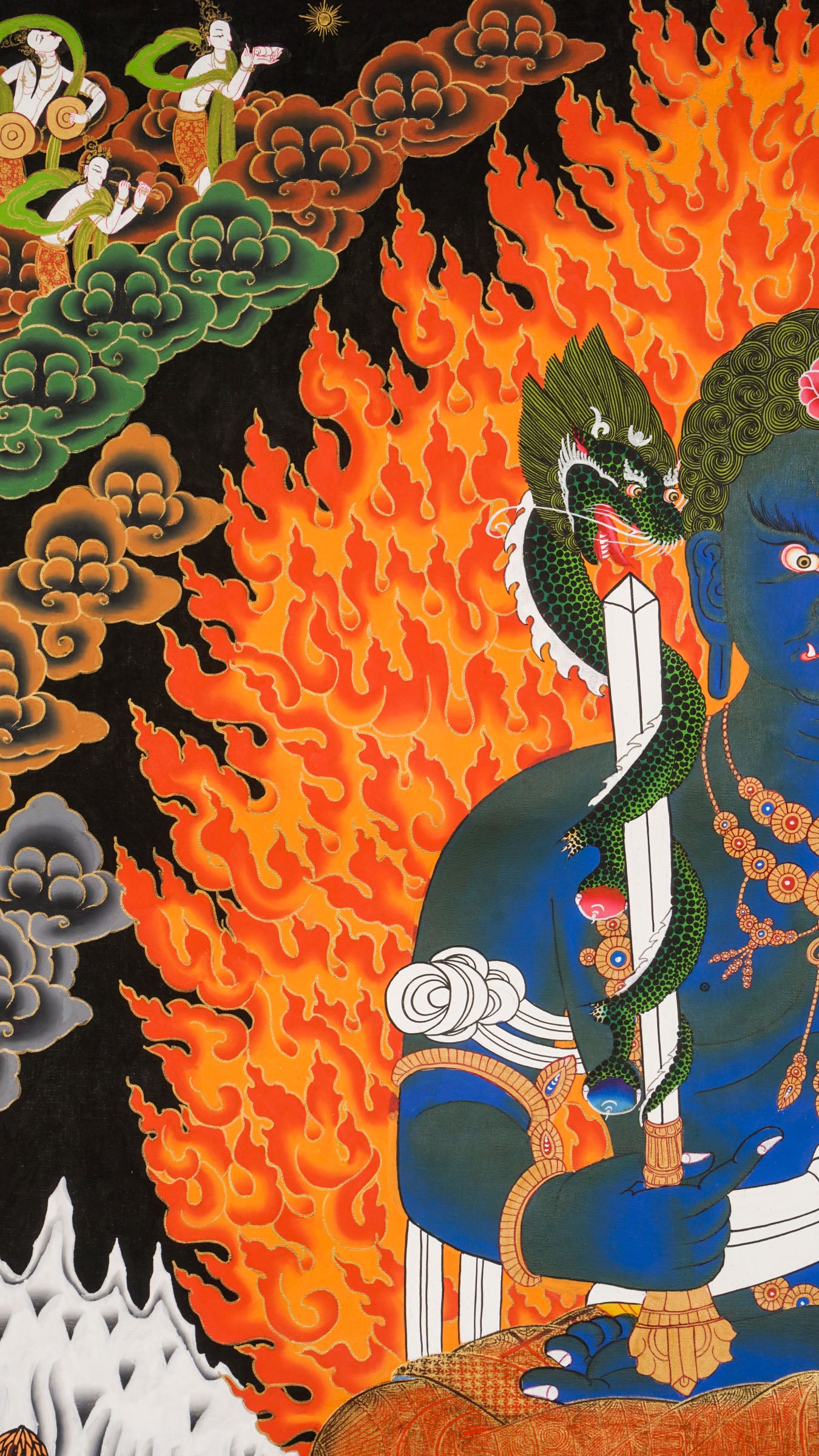 Traditional Tibetan thangka painting depicting Yamaraj, a blue-skinned wrathful deity seated on a lotus throne, surrounded by blazing flames, clouds, and symbolic ornaments against a dark background.