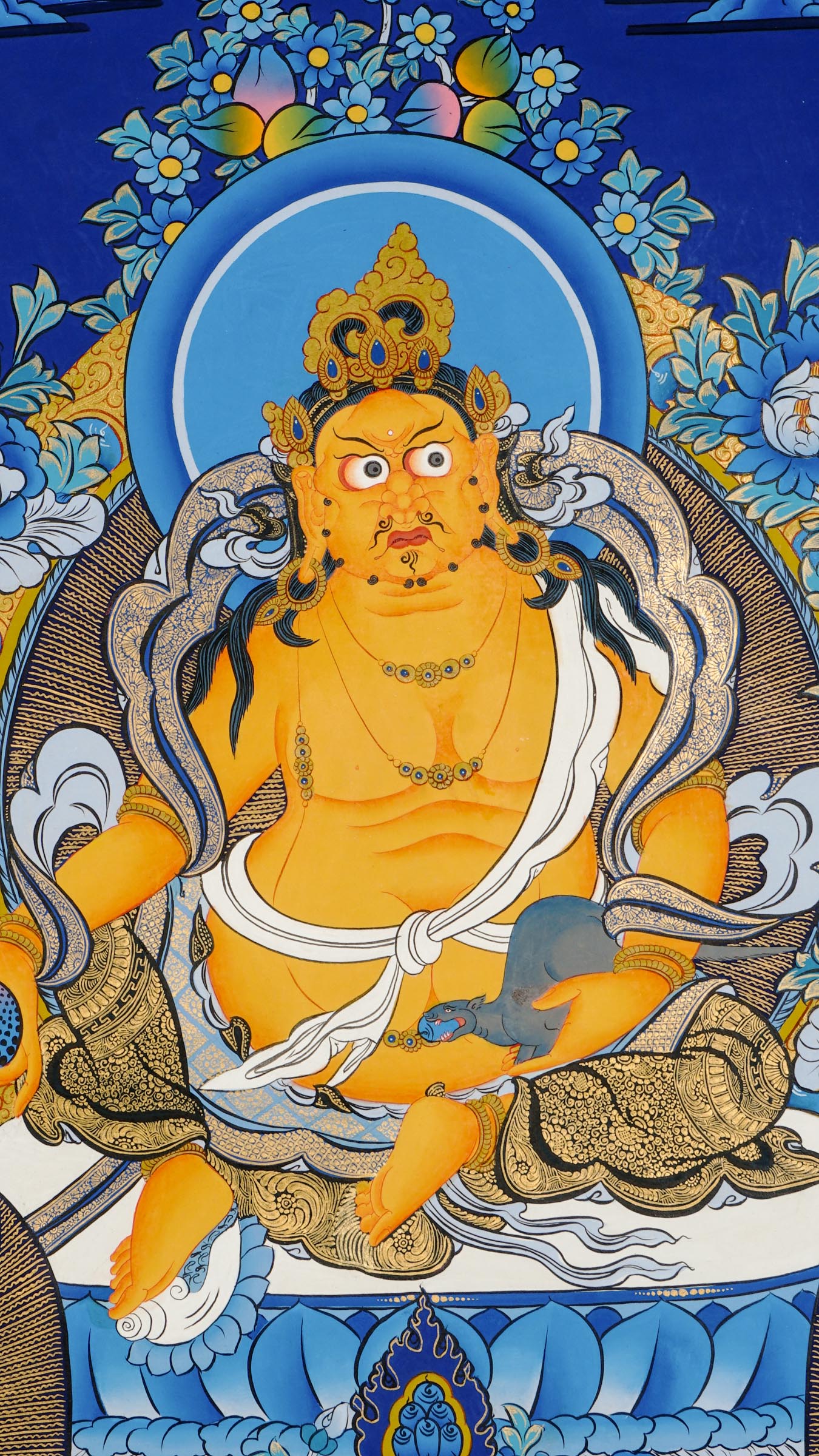 Tibetan thangka painting of Zambala, Buddhist god of wealth, handcrafted in Nepal with natural mineral pigments and 24k gold details, surrounded by deities and lotus motifs.