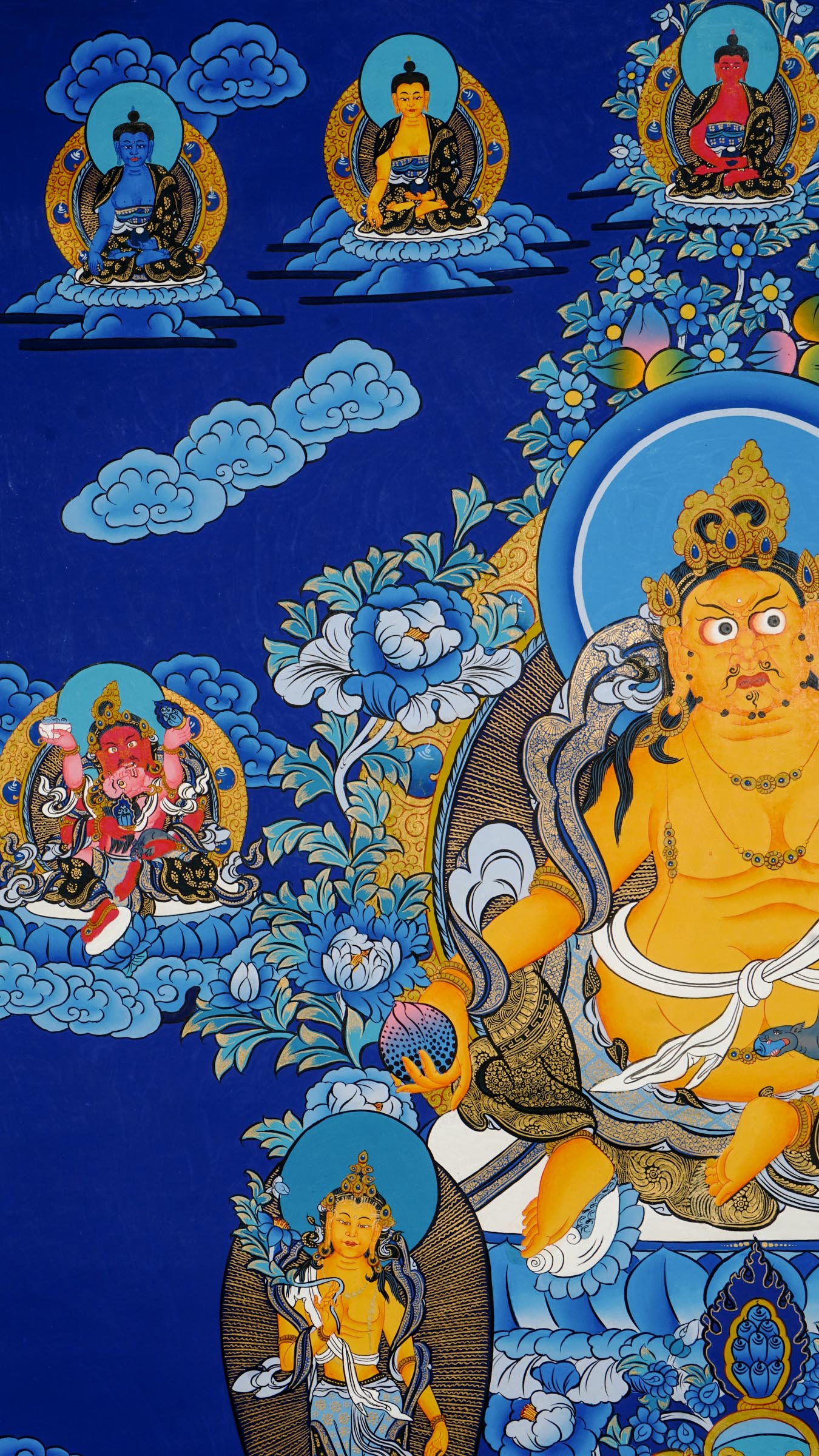 Tibetan thangka painting of Zambala, Buddhist god of wealth, handcrafted in Nepal with natural mineral pigments and 24k gold details, surrounded by deities and lotus motifs.