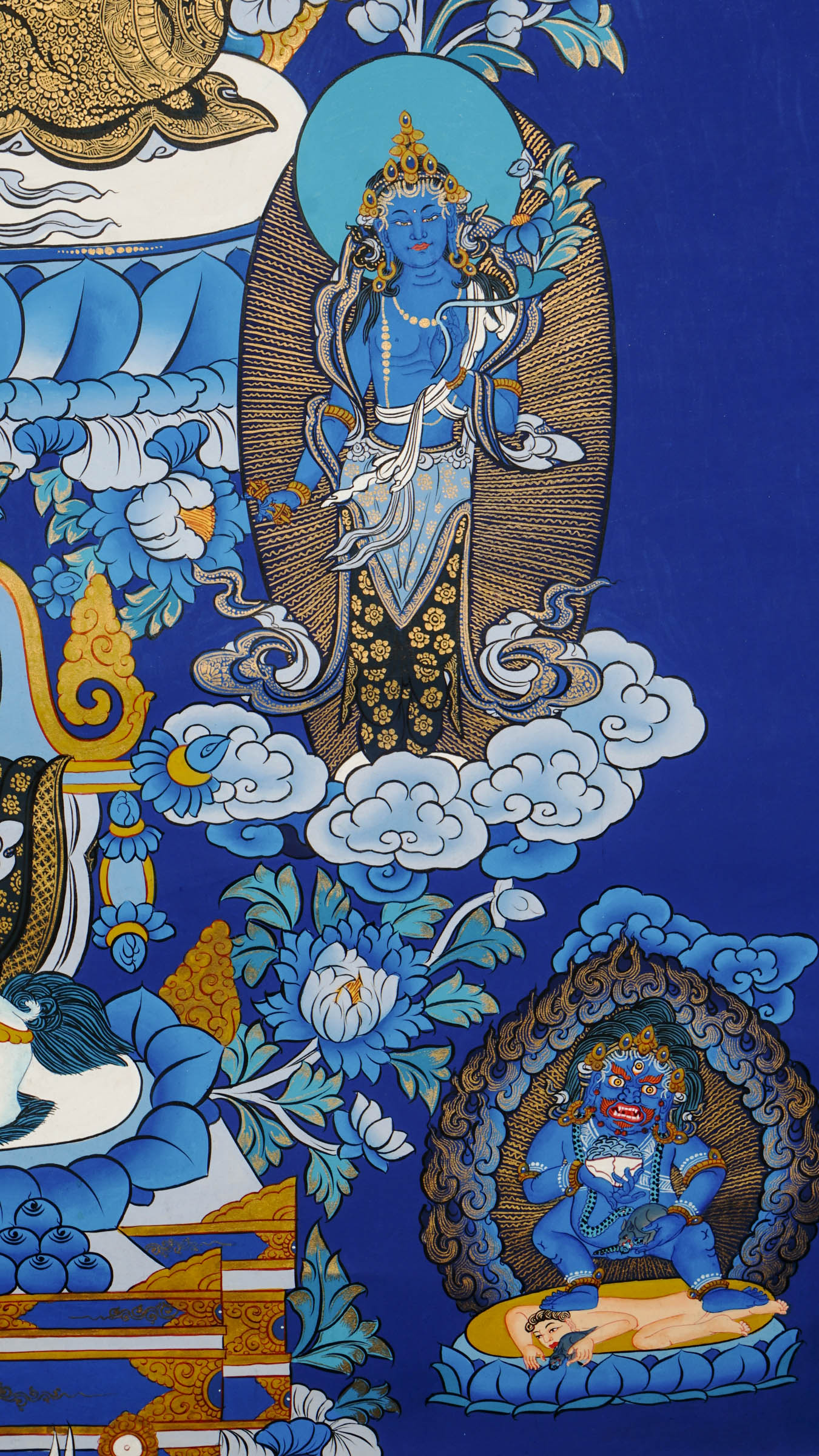 Tibetan thangka painting of Zambala, Buddhist god of wealth, handcrafted in Nepal with natural mineral pigments and 24k gold details, surrounded by deities and lotus motifs.