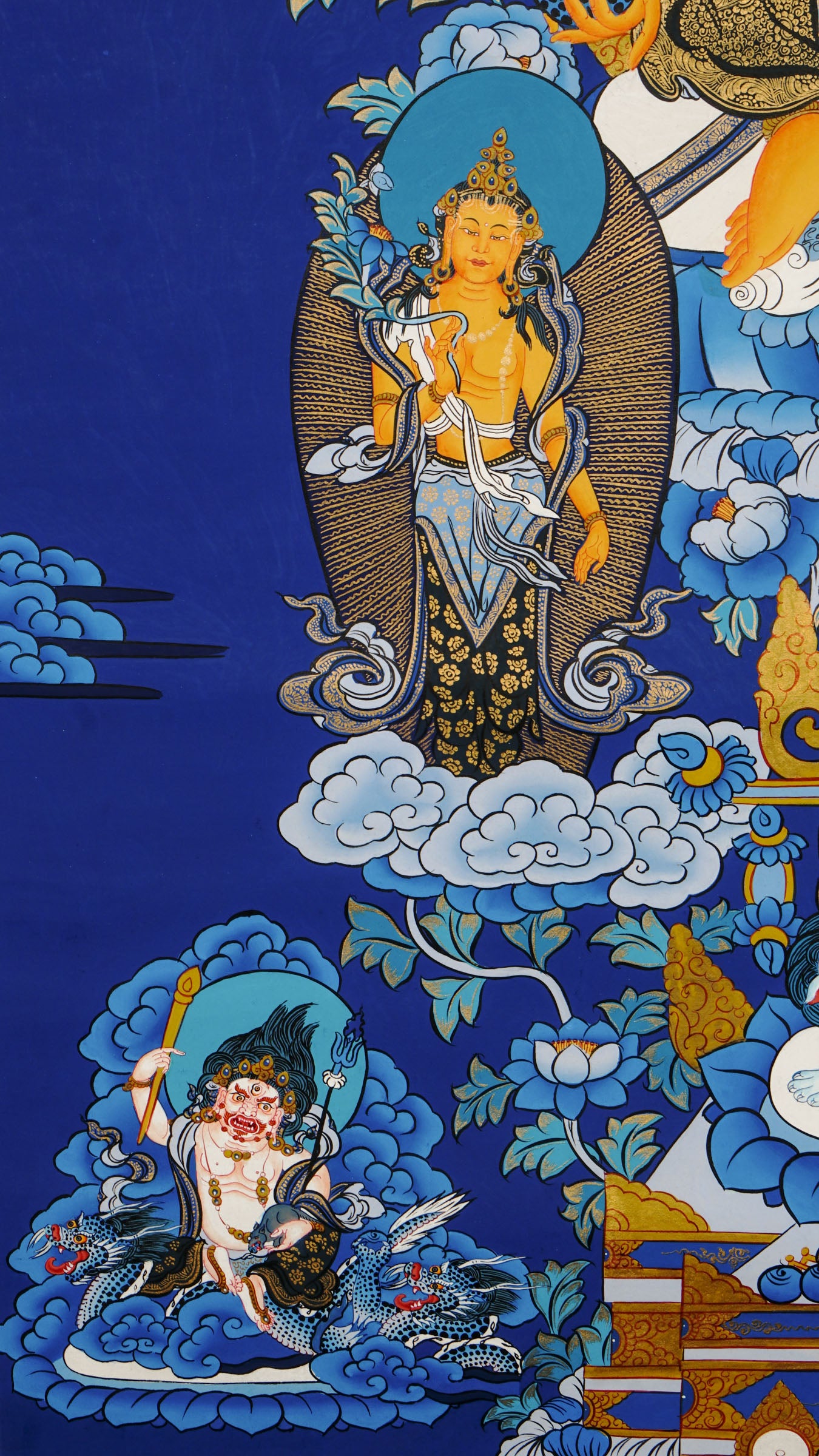 Tibetan thangka painting of Zambala, Buddhist god of wealth, handcrafted in Nepal with natural mineral pigments and 24k gold details, surrounded by deities and lotus motifs.
