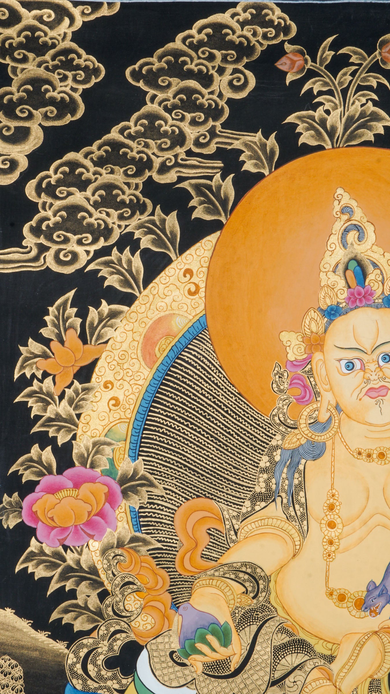 Zambala is a Tibetan Buddhist deity of wealth and prosperity. This genuine Thangka shows him seated on a lotus throne, holding a jewel-spouting mongoose and a symbol of fulfillment.