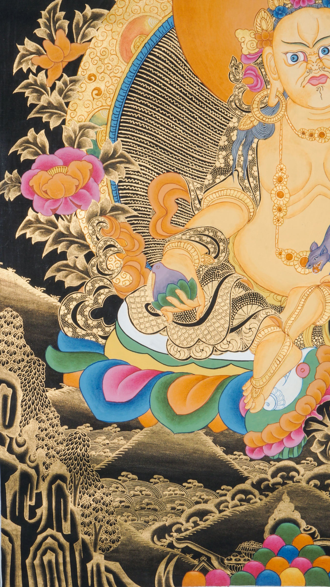 Zambala is a Tibetan Buddhist deity of wealth and prosperity. This genuine Thangka shows him seated on a lotus throne, holding a jewel-spouting mongoose and a symbol of fulfillment.