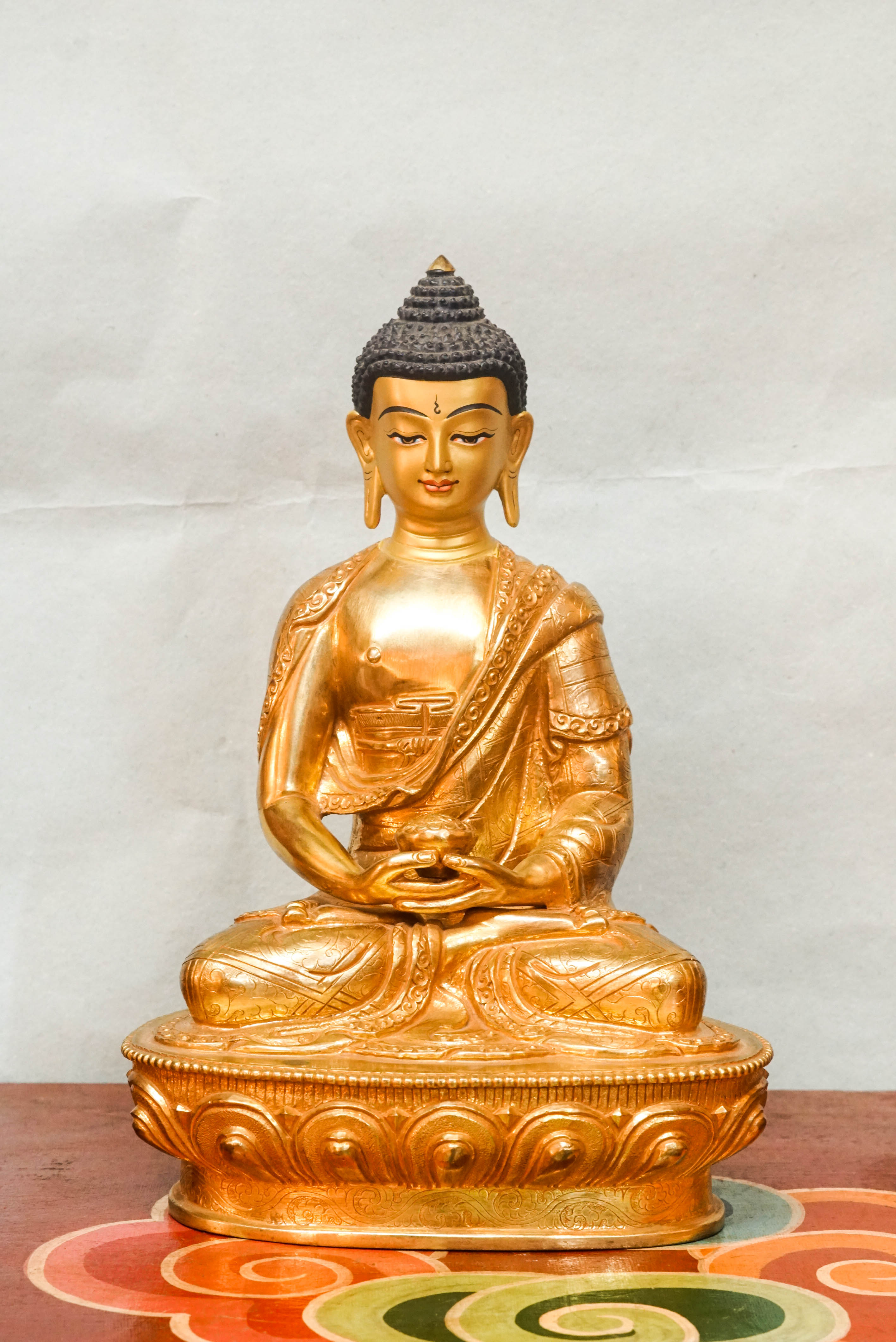 Gold Buddha statue with detailed robes and calm facial features, symbolizing spiritual awakening and inner harmony.