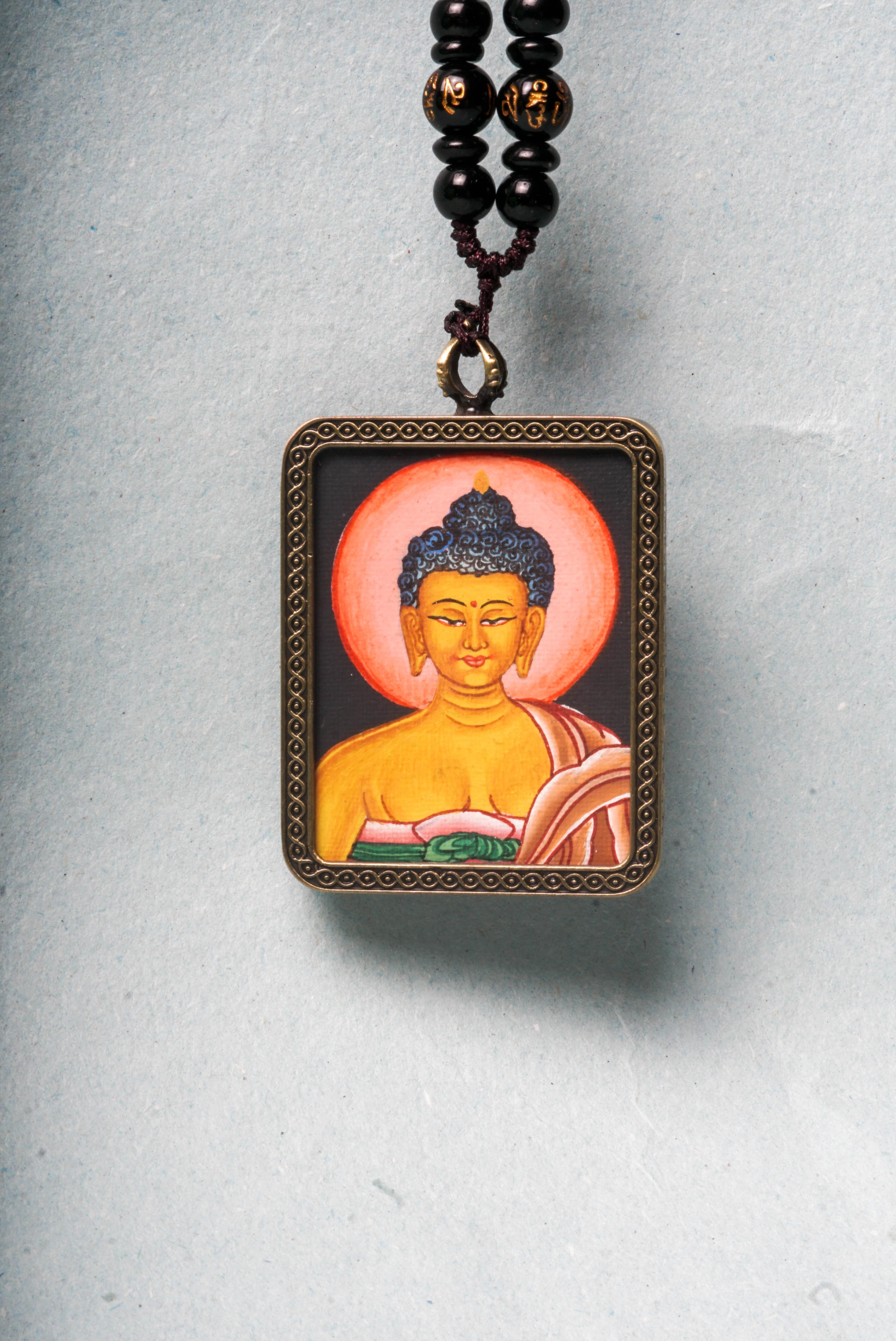 This Buddha Ghau Thangka captures the serene wisdom and compassion of the Buddha in a detailed, hand-painted portrait using natural mineral pigments. Designed as a portable shrine, it offers spiritual support whether carried or displayed, inspiring inner peace and mindfulness in daily practice.