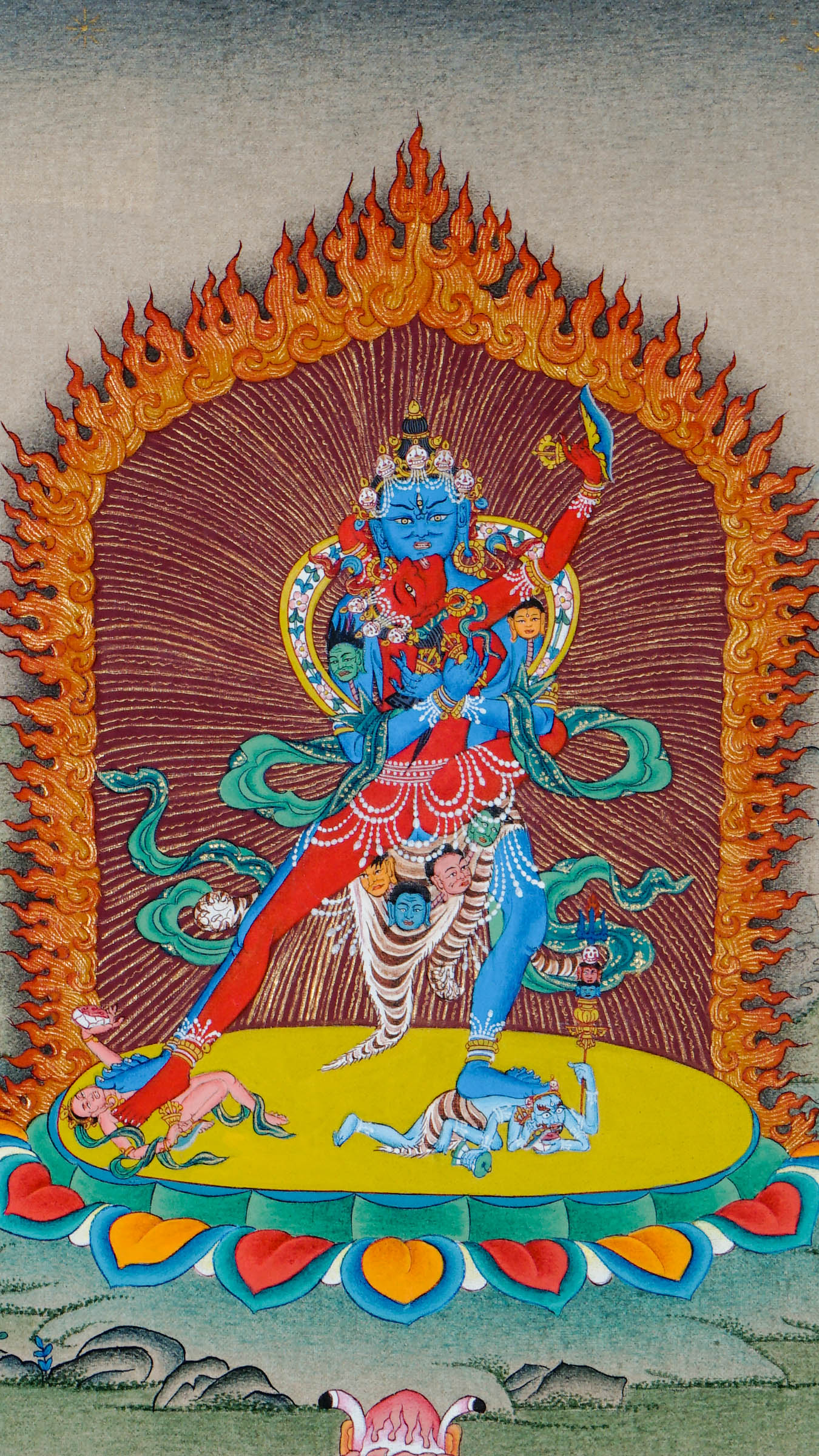 Tibetan thangka painting of Chakrasamvara in union with Vajravarahi, standing on a lotus throne above subdued figures, surrounded by flames, adorned with jewels and skull garlands, hand painted in Kathmandu, Nepal.