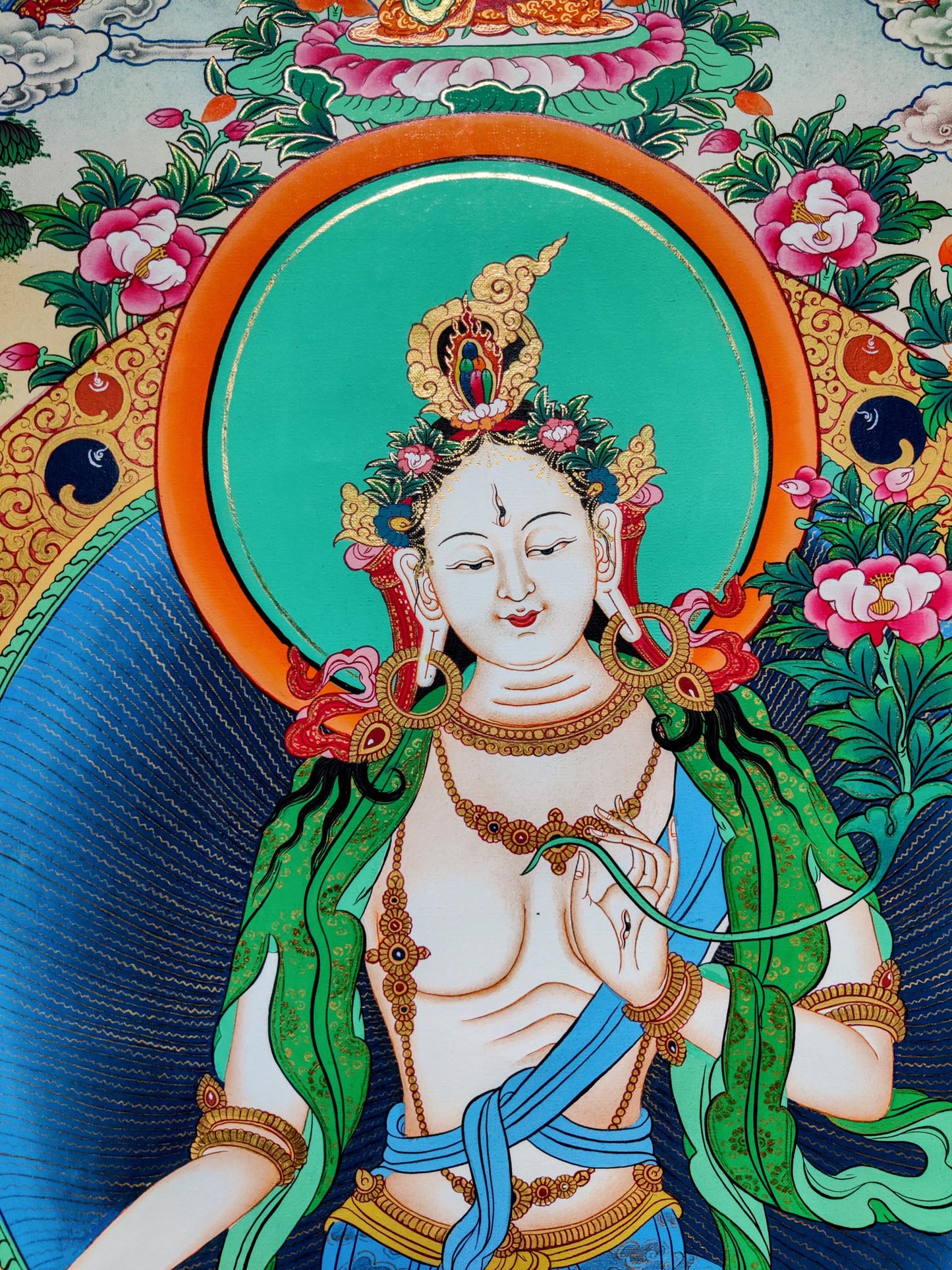 The White Thangka Painting is hand-painted in 24k gold leaf accents, as a sign of heavenly blessings and purity.