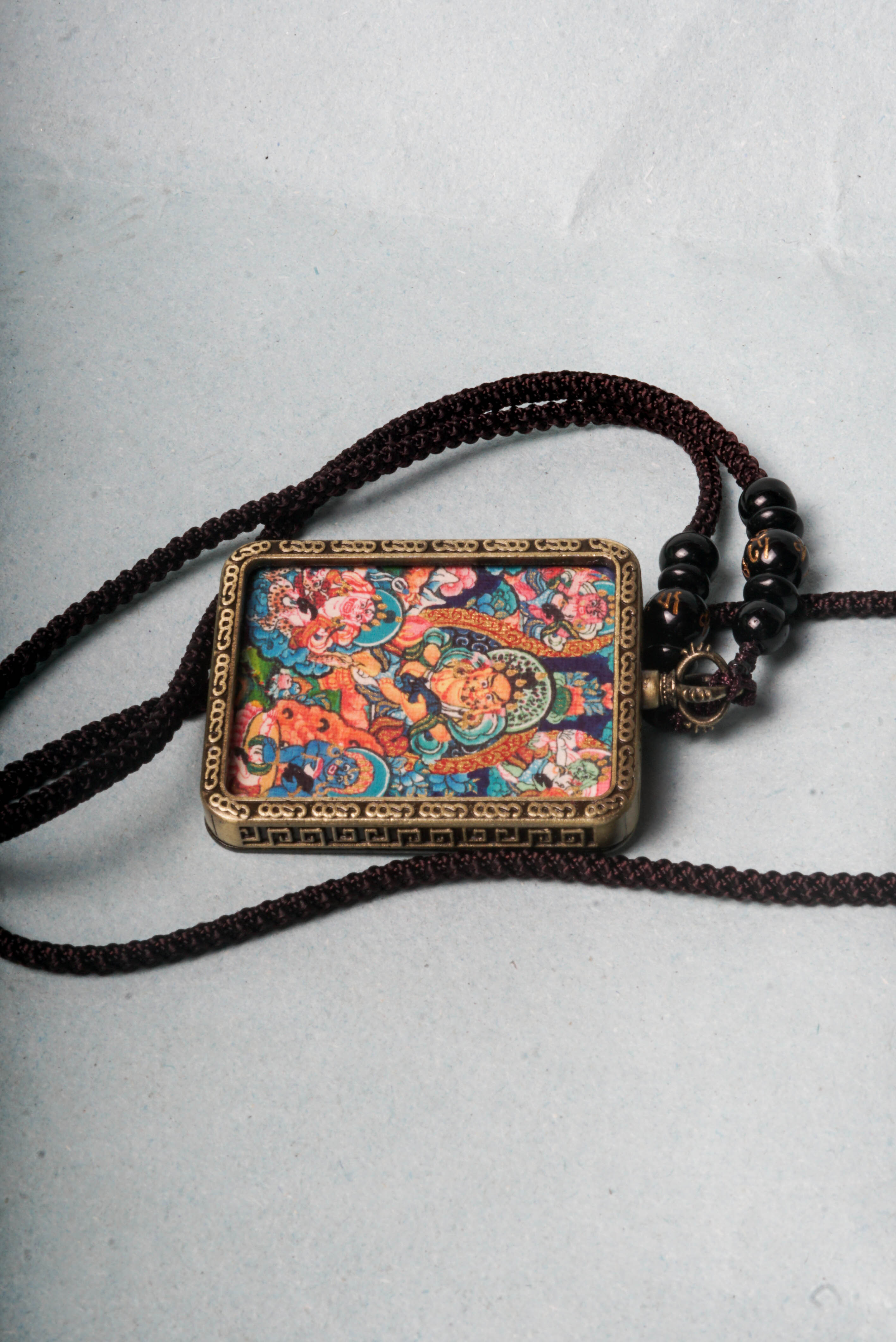 The genuine Five Zambala Ghau Thangka features all five Tibetan Buddhist wealth deities, symbolizing prosperity, generosity, and the removal of obstacles. Hand-painted with natural mineral pigments, this portable shrine is both a powerful talisman and sacred artwork for attracting abundance and spiritual growth.