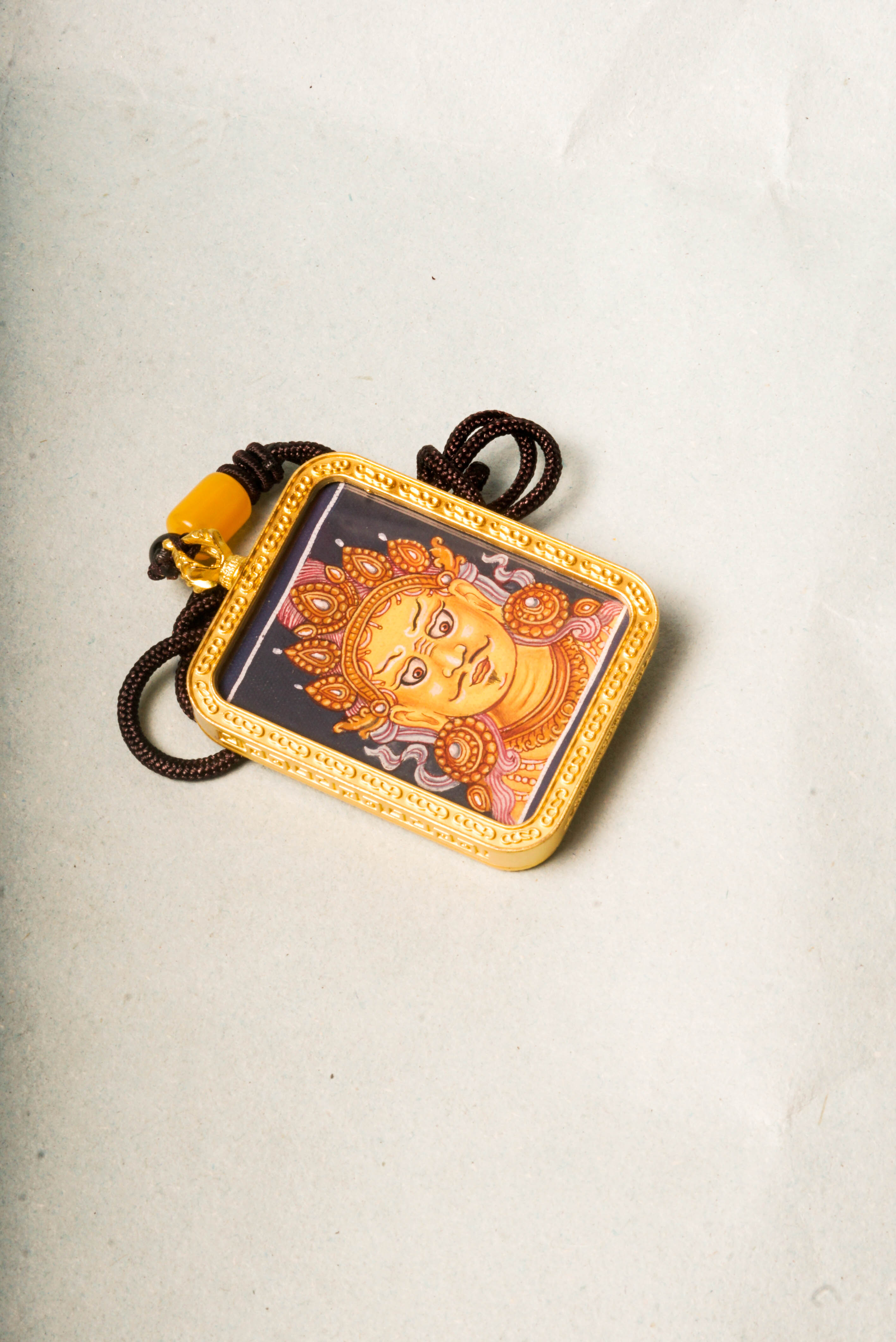 This Newari Zambala Ghau Thangka depicts the Tibetan Buddhist god of wealth holding a jewel-spouting mongoose, symbolizing prosperity and protection. Handcrafted in vibrant Newari style, it's ideal for personal altars or as a spiritual amulet.