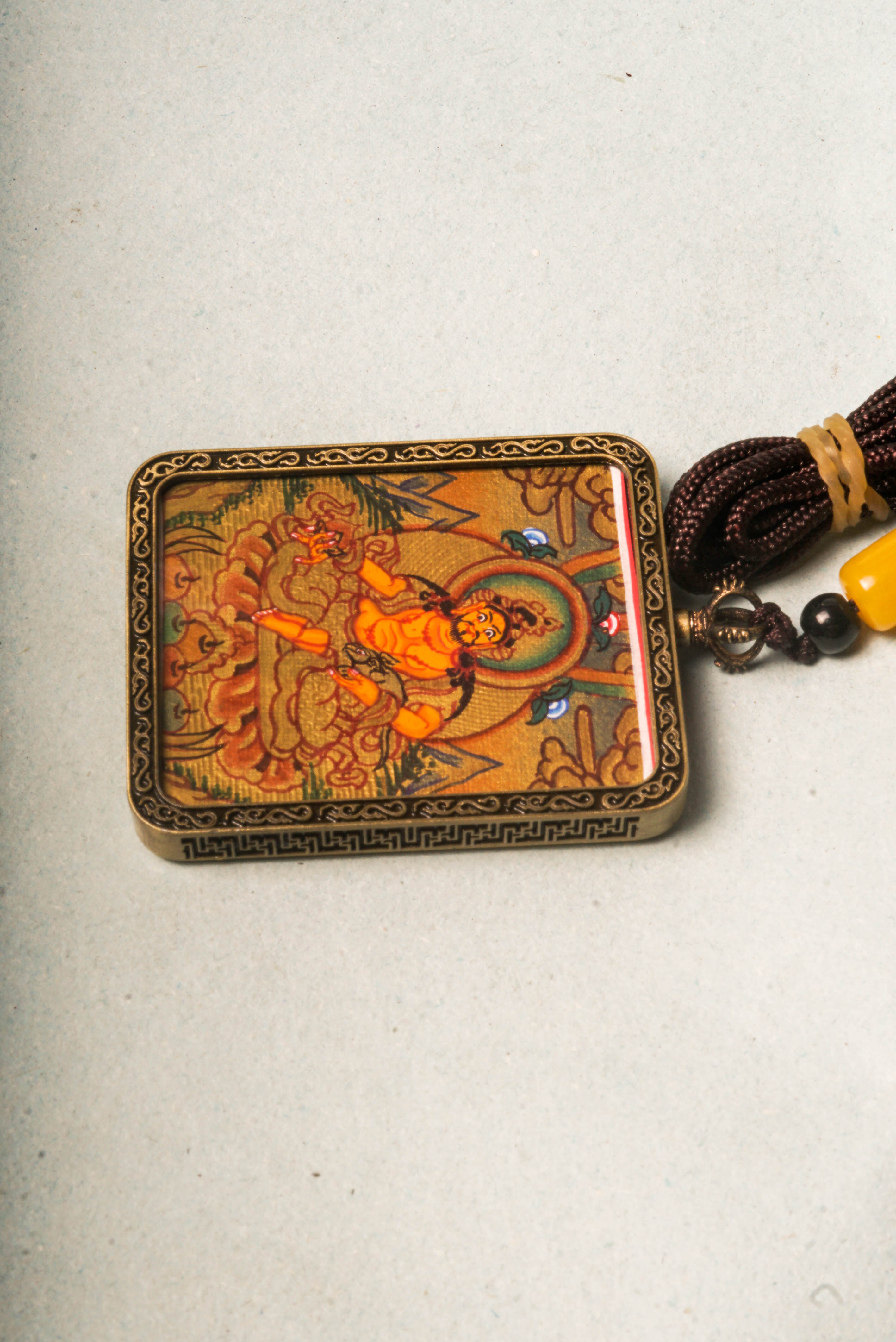 Zambala, the Tibetan Buddhist deity of wealth and prosperity, is revered for attracting abundance and removing obstacles. This Gold Zambala Thangka, hand-painted with mineral pigments and gold accents, embodies his blessings and brings spiritual harmony and success to your space.