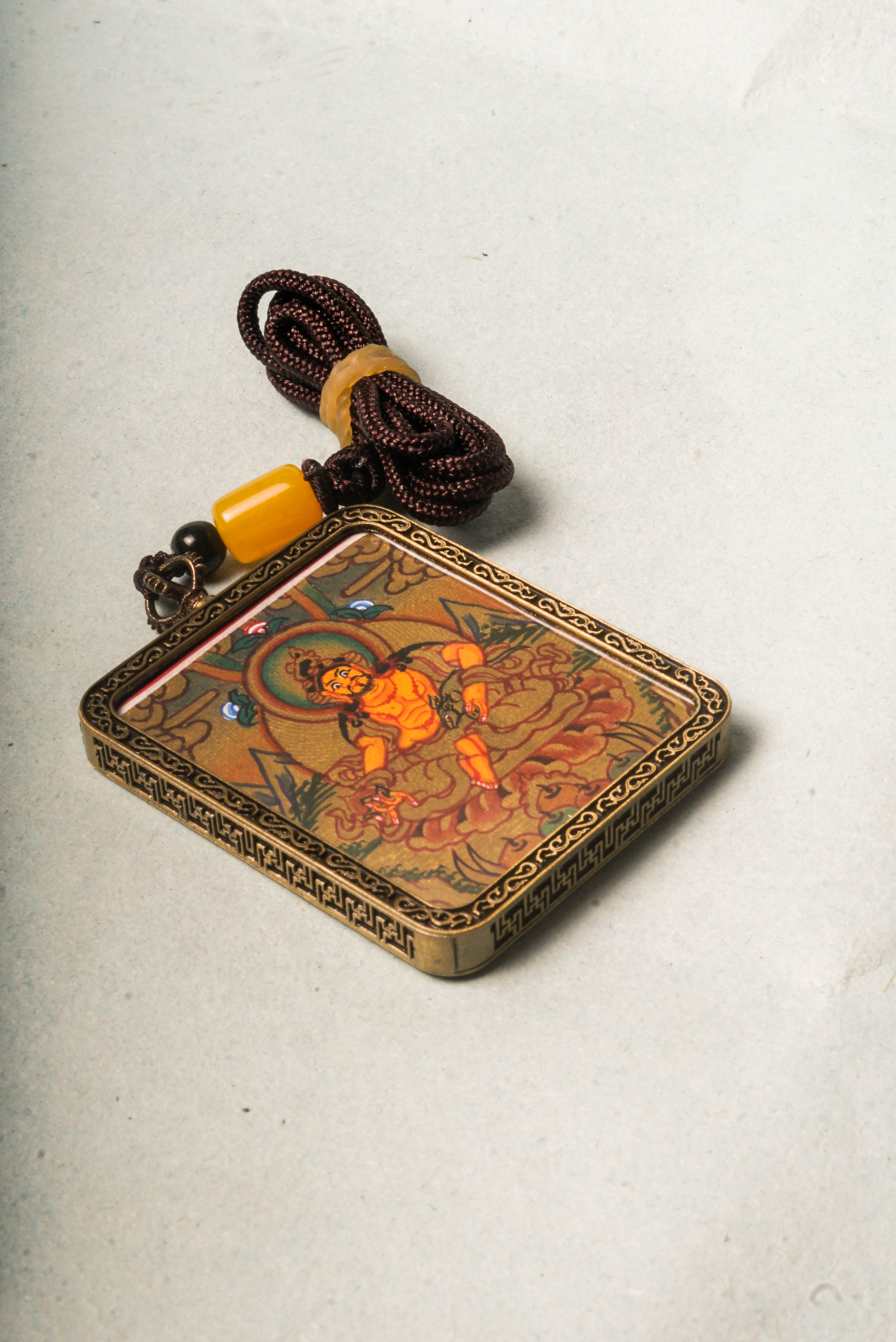 Zambala, the Tibetan Buddhist deity of wealth and prosperity, is revered for attracting abundance and removing obstacles. This Gold Zambala Thangka, hand-painted with mineral pigments and gold accents, embodies his blessings and brings spiritual harmony and success to your space.